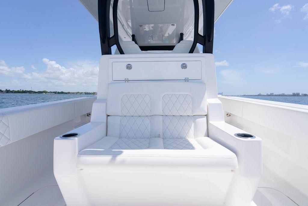 Luxurious seating on the 2027 Reef Runner 340 boat, featuring elegant white upholstery.