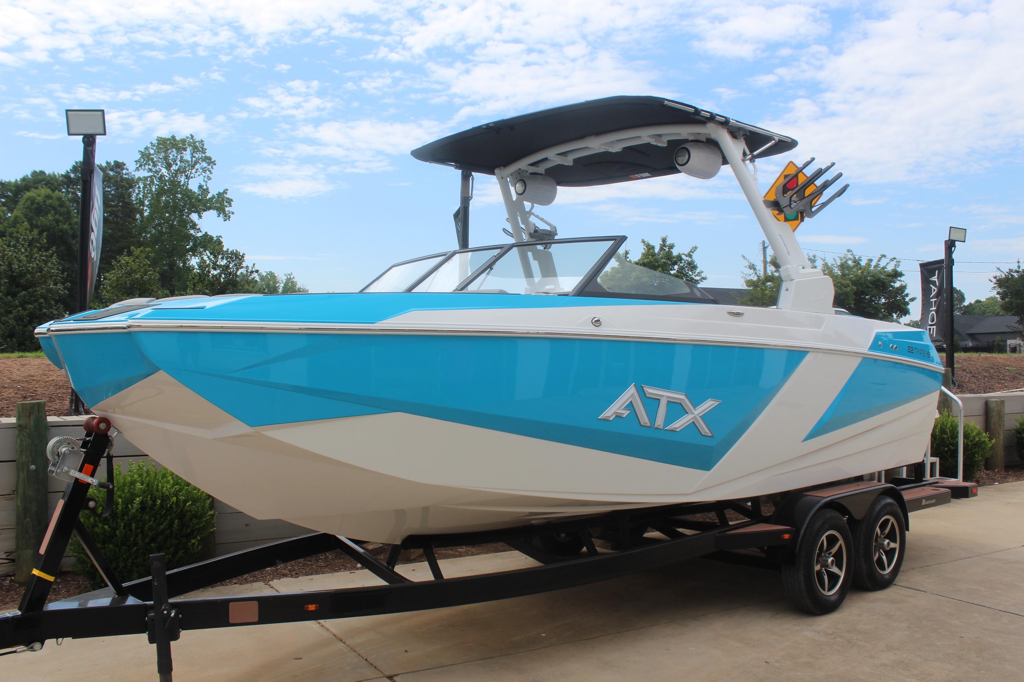 2026 ATX Surf Boats 22 Type-S in blue and white on a trailer, outdoors.