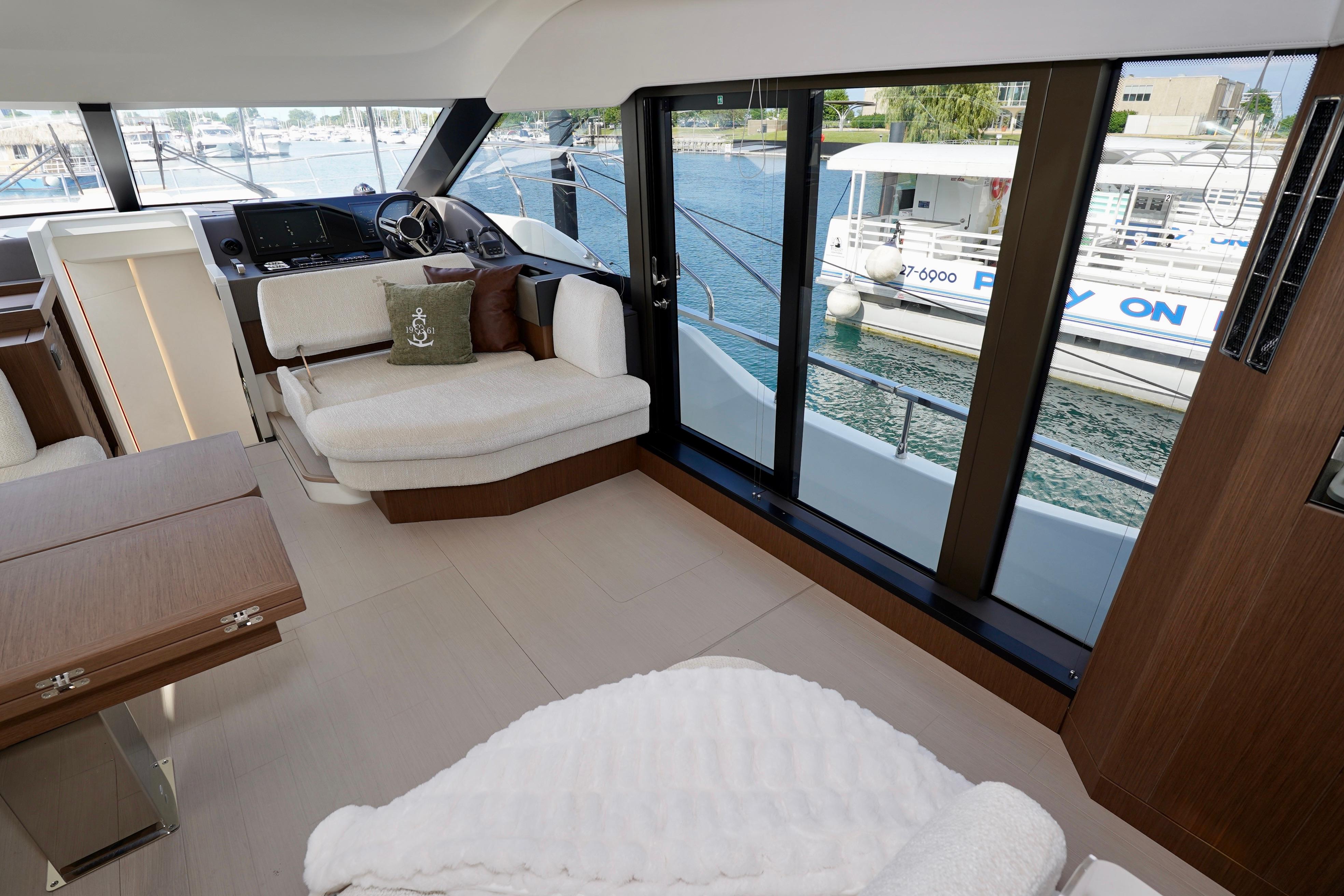 Luxurious interior of 2025 Prestige F5.7 yacht with modern seating and large windows.