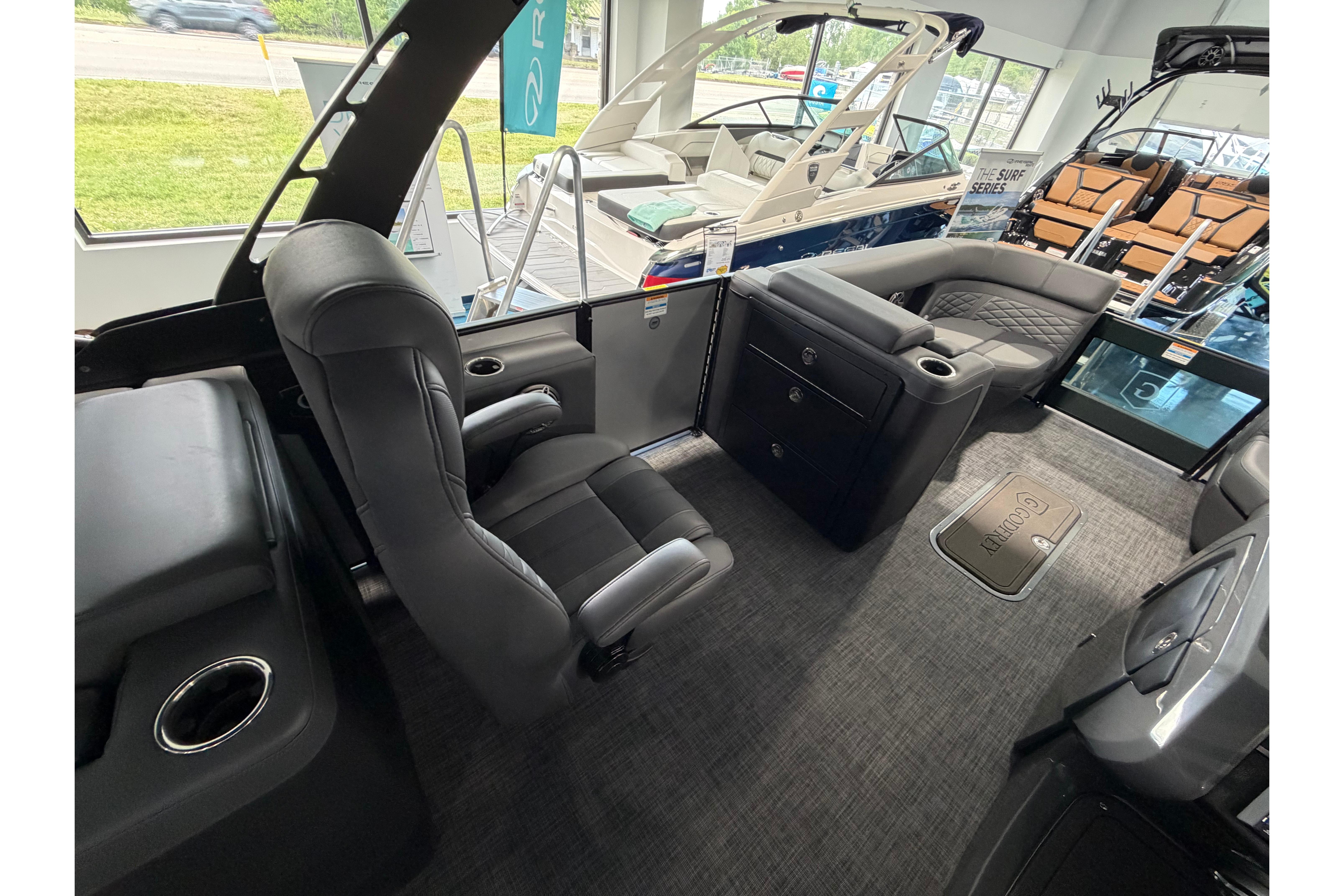 Luxurious interior of 2026 Godfrey Monaco 235ULC pontoon boat with plush seating and modern design.
