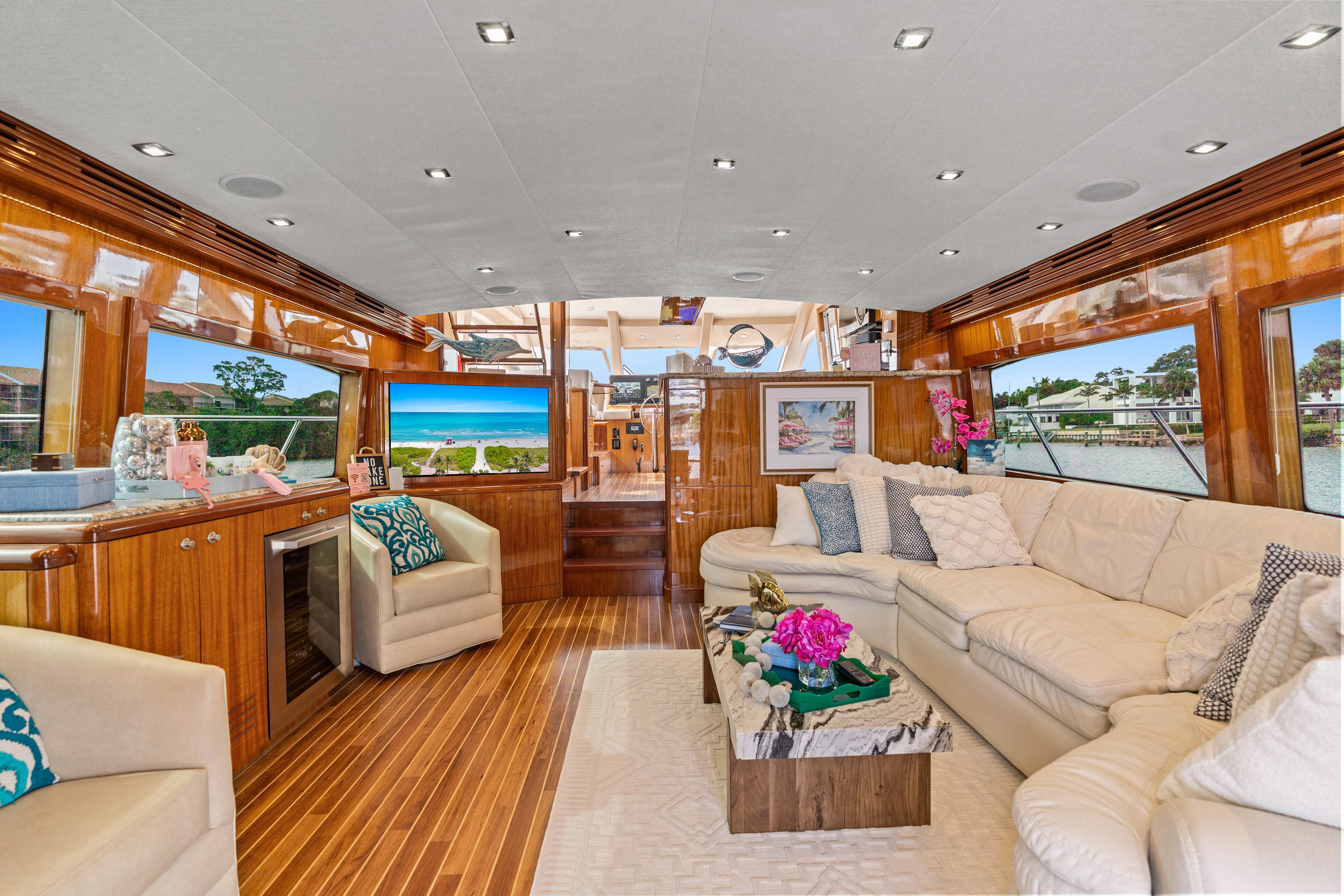 Luxurious interior of 2008 Hatteras 64 Motor Yacht with elegant seating and scenic views.
