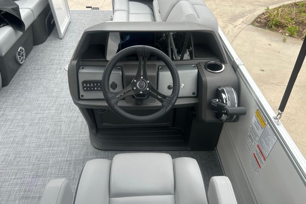 2026 Sun Tracker Party Barge 22 RF DLX steering console with modern controls and seating.