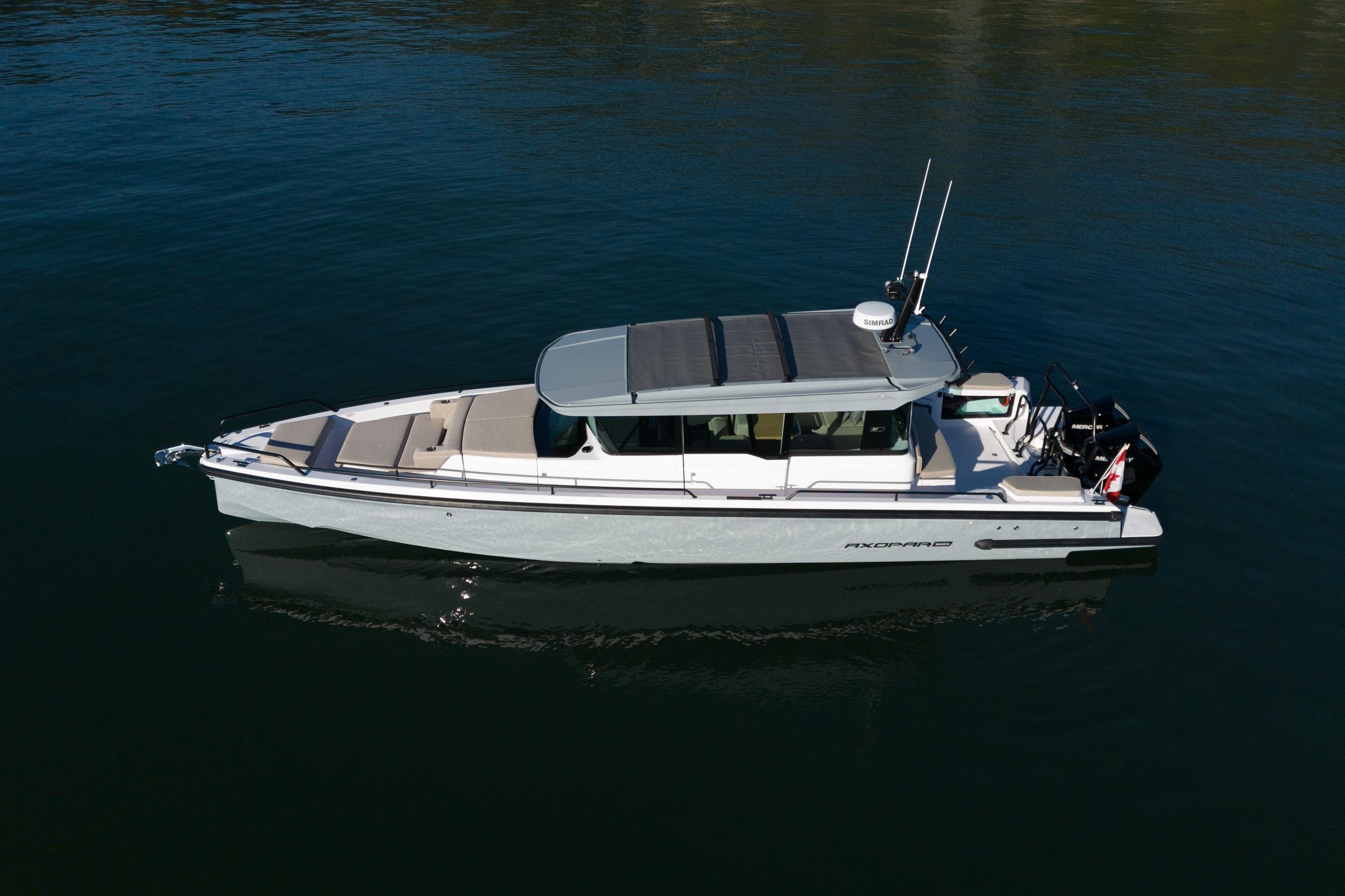 2026 Axopar 37XC Aft Cabin boat on calm water, side view.