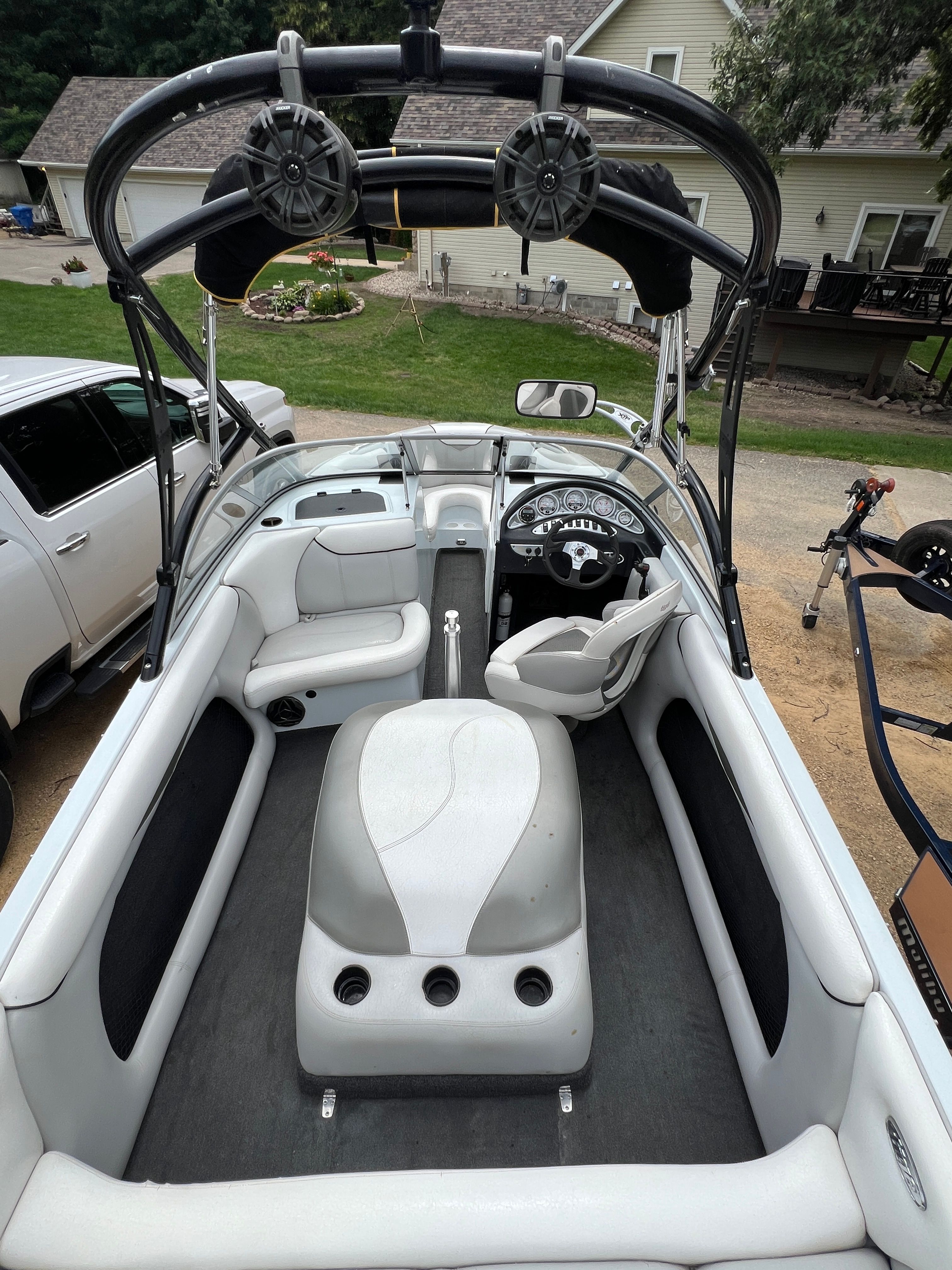 Interior view of a 2006 Tigé 20i boat with white upholstery and black accents.
