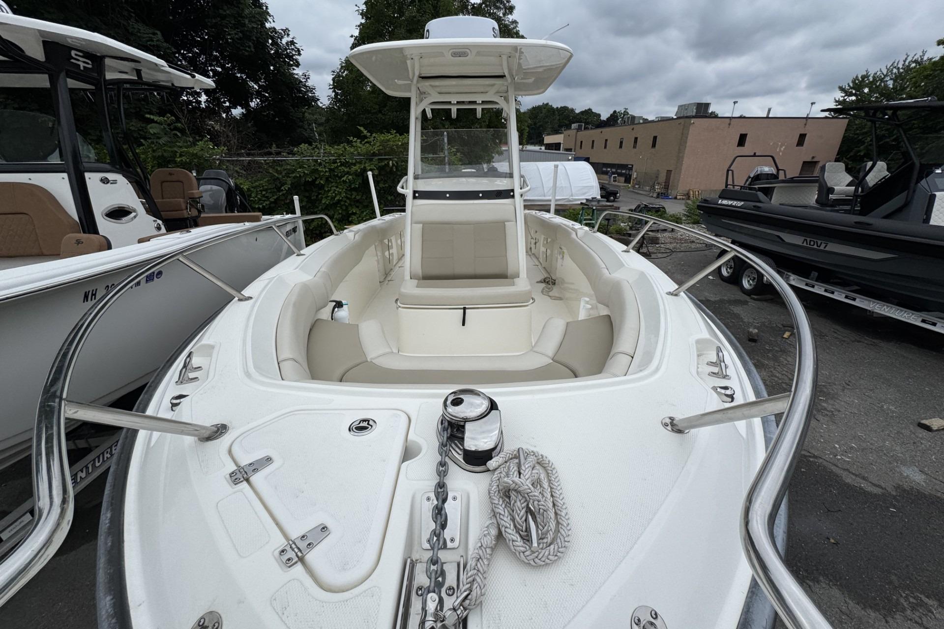 2024 Boston Whaler 230 Outrage boat with spacious seating and sleek design.