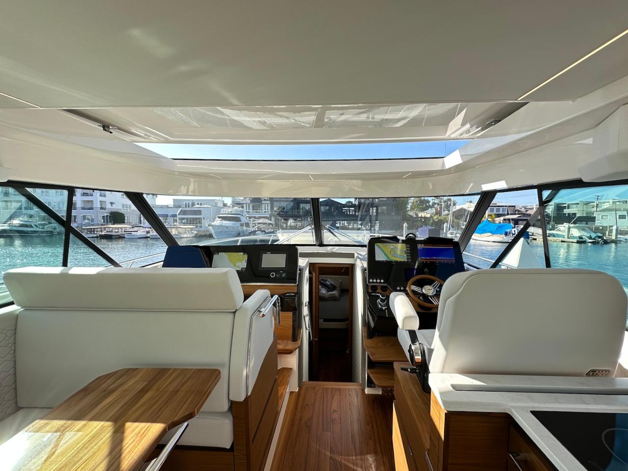 Interior view of 2025 Tiara Yachts 48 LE, showcasing helm and seating area.
