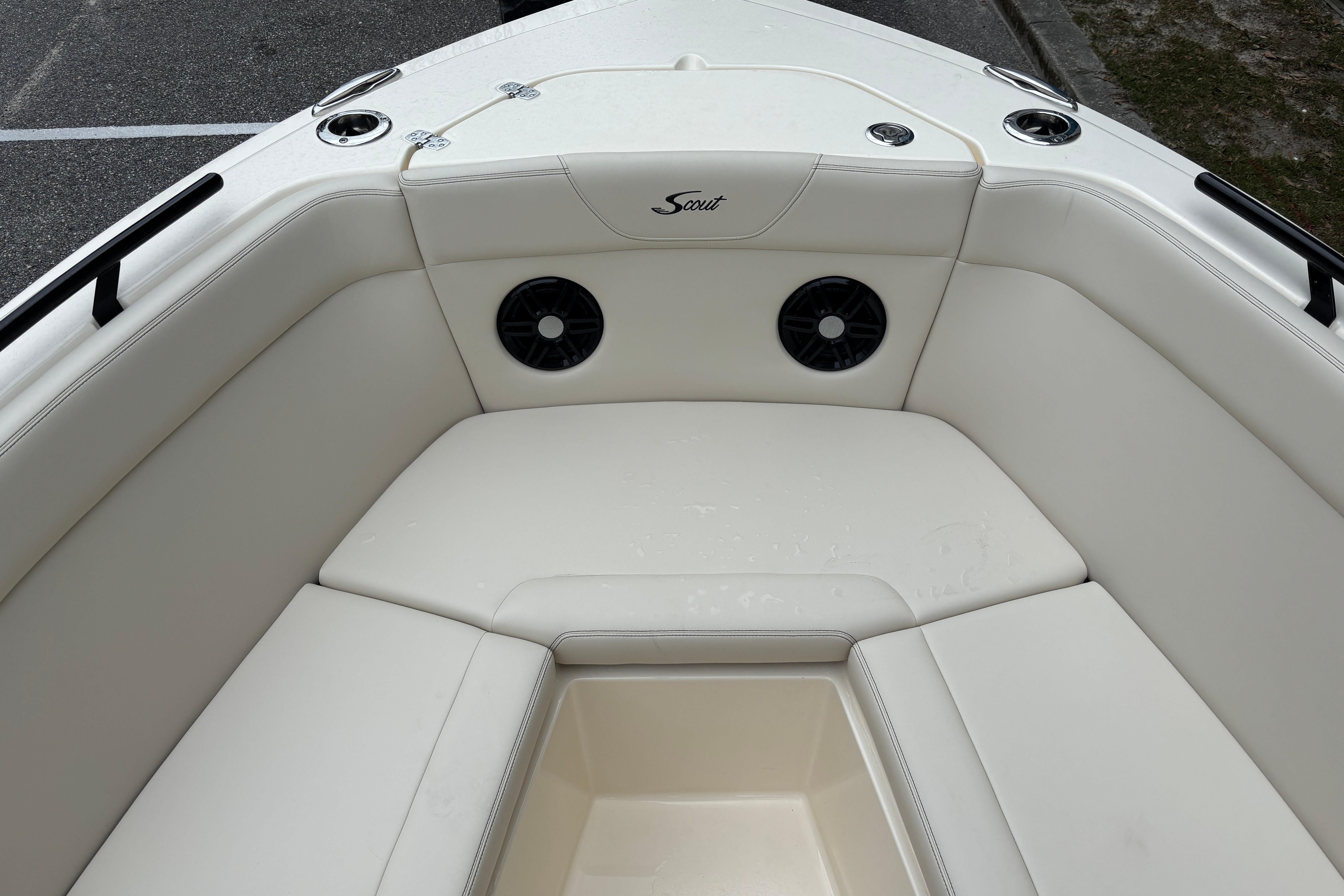 2026 Scout 240 Dorado boat interior with white seating and built-in speakers.