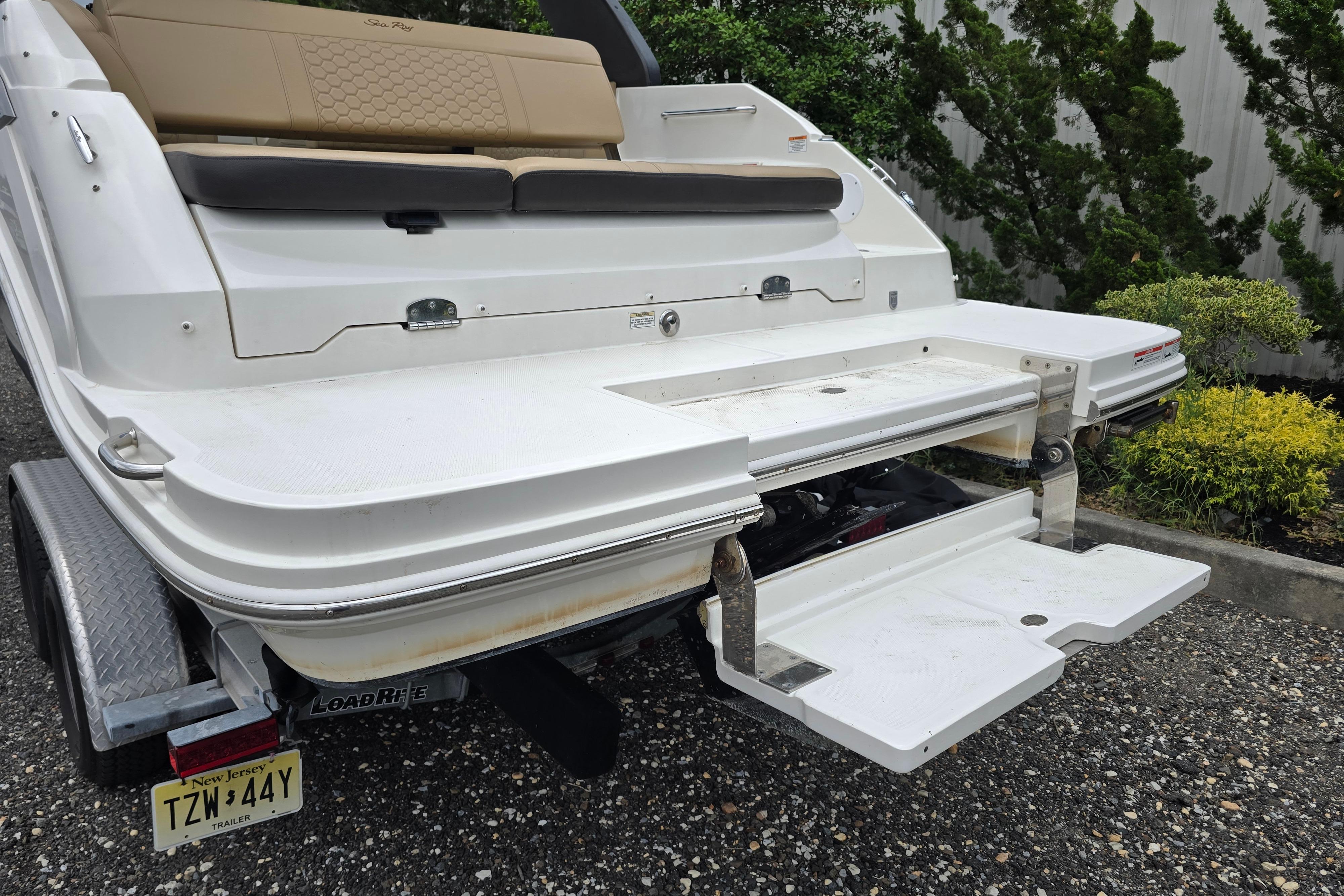 2019 Sea Ray SDX 250 boat rear view with swim platform and trailer.