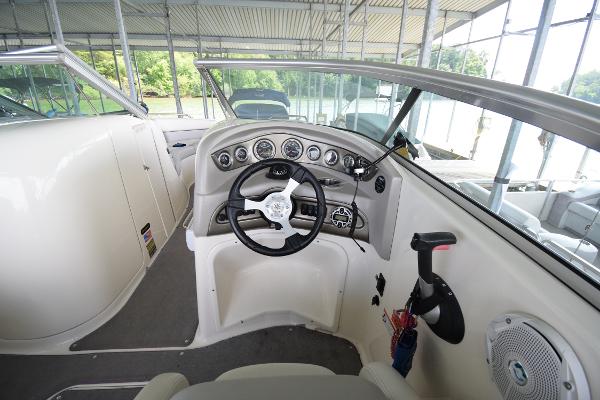 The image shows the cockpit of a 2010 Bryant 255 boat with a modern helm.