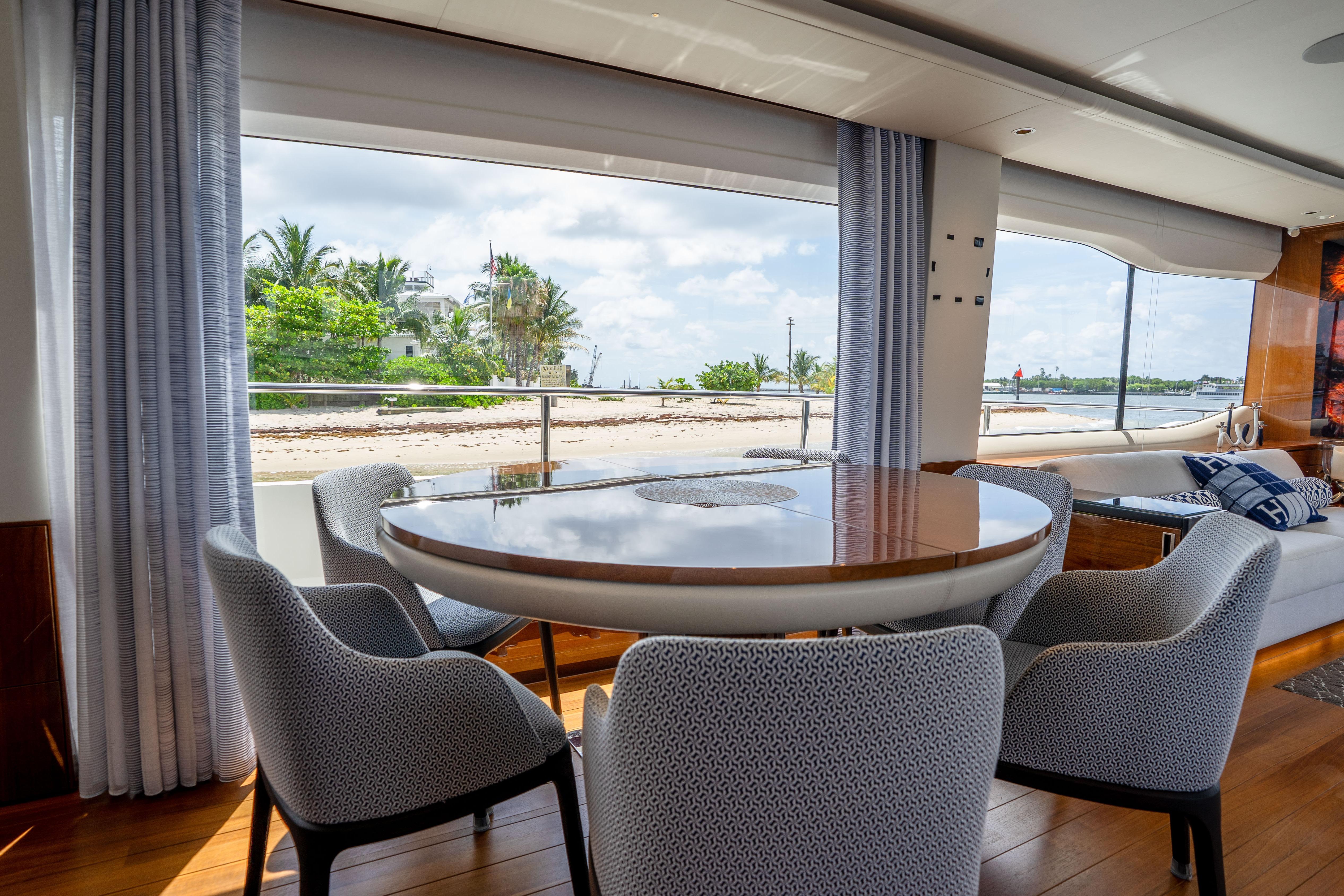 Luxurious interior of 2020 Princess Y85 yacht with elegant dining area and scenic ocean view.