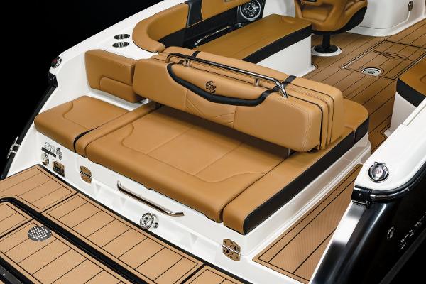2024 Chaparral 28 Surf boat interior with tan leather seating and sleek design.