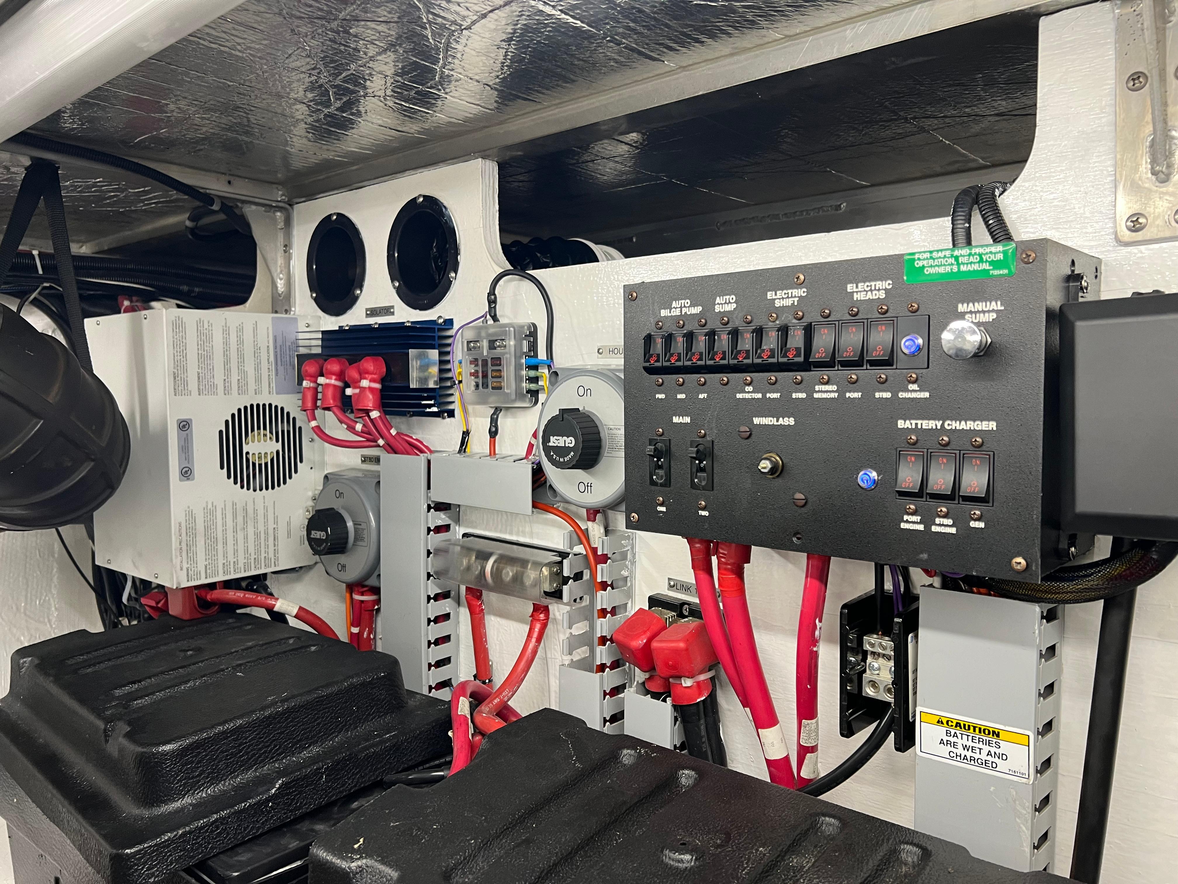 Engine room of 2001 Carver 450 Voyager Pilothouse with electrical panels and wiring.