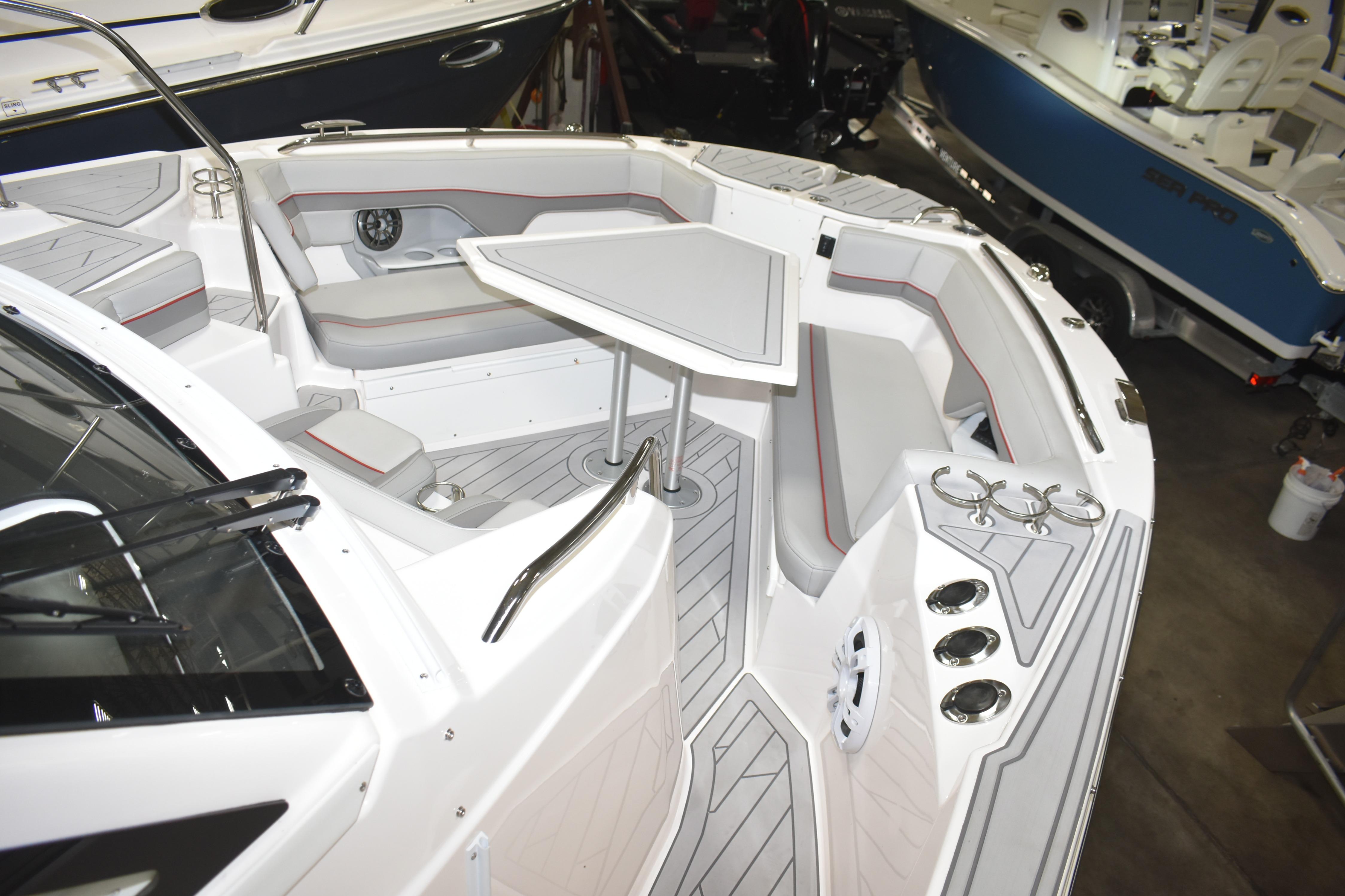 2025 Solara S-310 CW boat interior with seating, table, and cup holders.