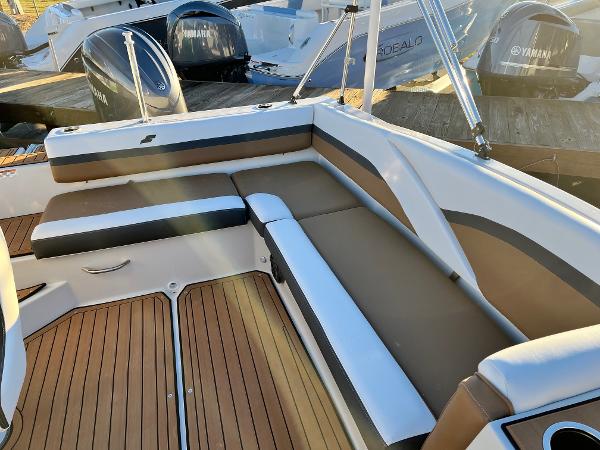 2024 Starcraft SVX 191 boat interior with cushioned seating and wooden flooring.