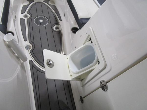 2017 Larson 292 LXI boat interior with open storage compartment.