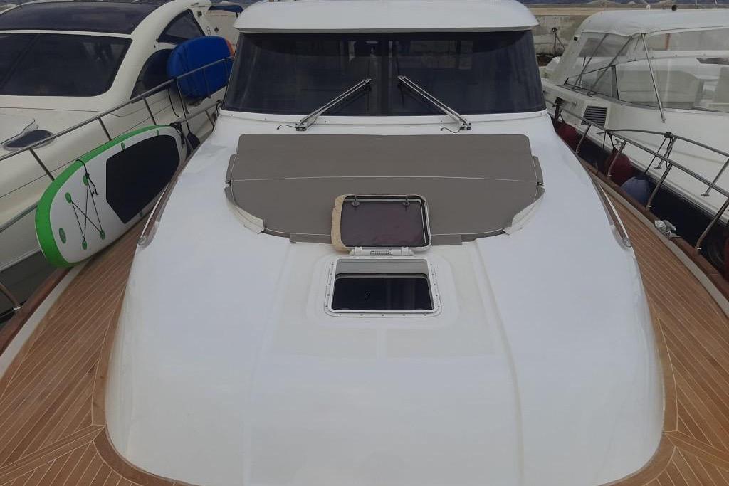 2005 Mochi Dolphin 51 yacht with sleek deck design and paddleboard on the side.
