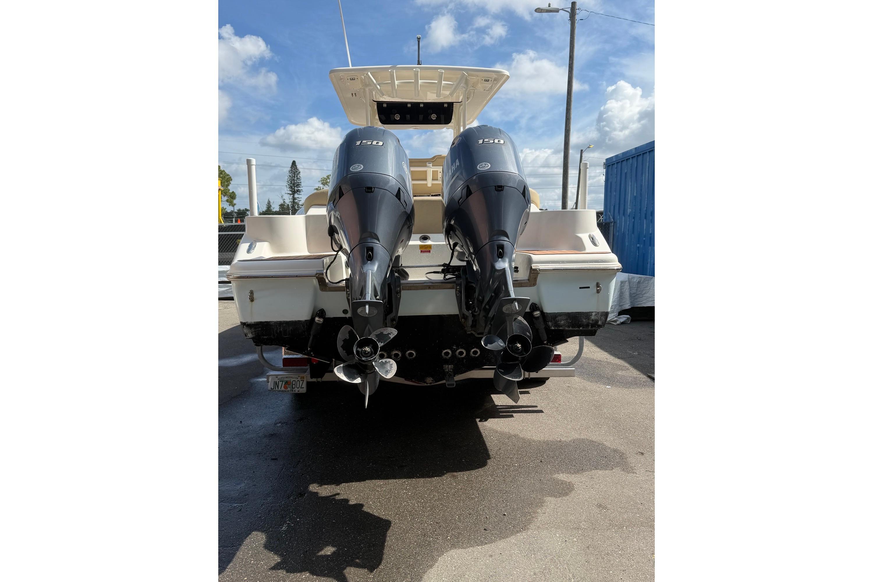 2019 Key West 263 FS boat with dual 150 horsepower outboard motors, parked outdoors.