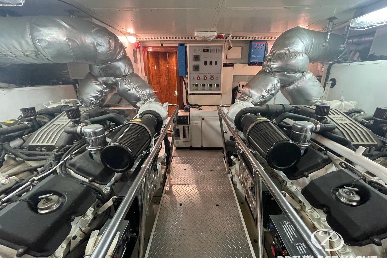 Engine room of a 2006 Monte Fino 76 yacht, featuring dual engines and control panels.