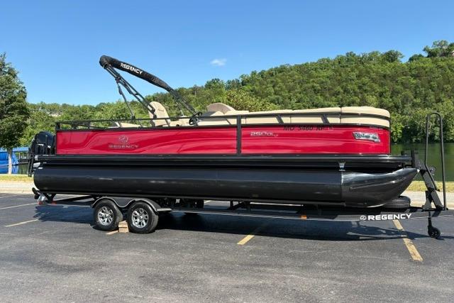 2025 Regency 250 DL3 pontoon boat on trailer, parked outdoors.