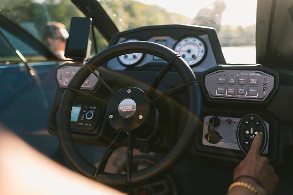 Manufacturer Provided Image: 2021 Axis A24 boat dashboard with steering wheel and control panel.