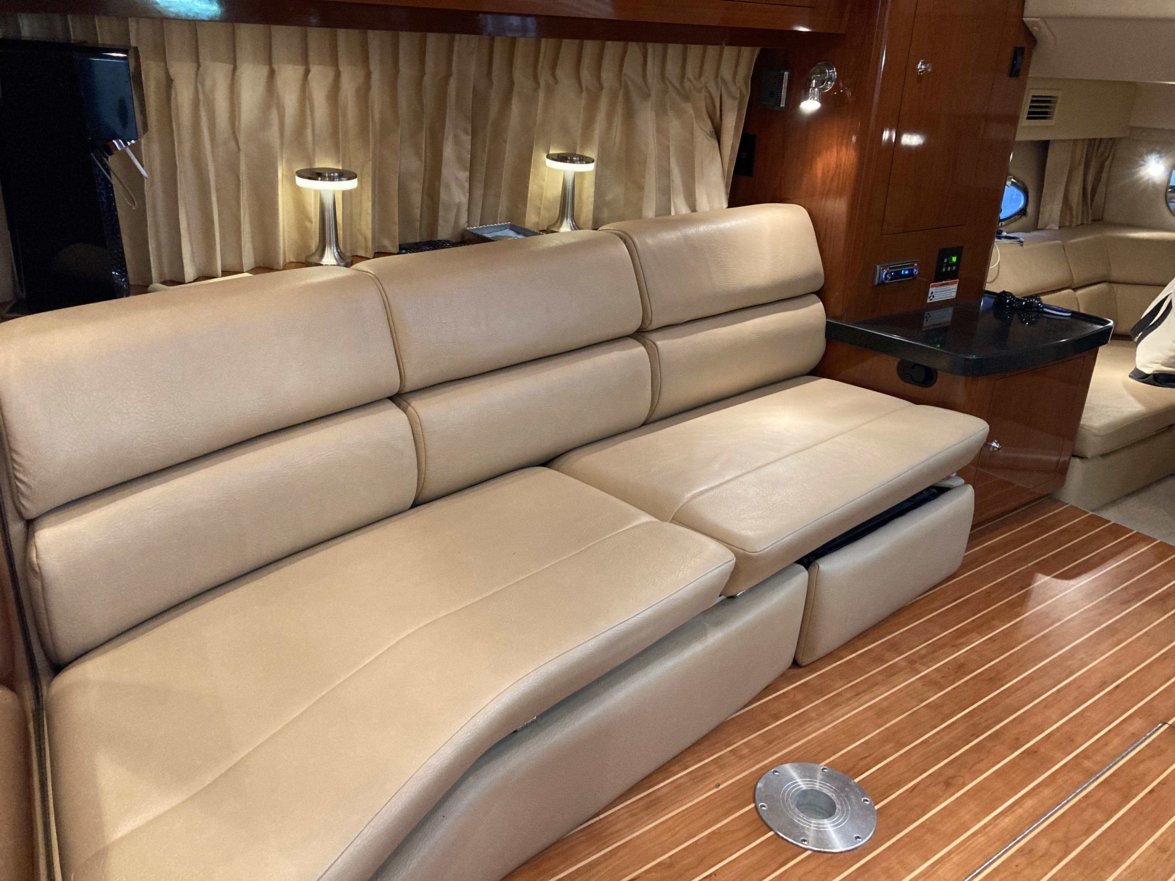 Luxurious interior of 2007 Regal 3760 Commodore yacht with beige leather seating.