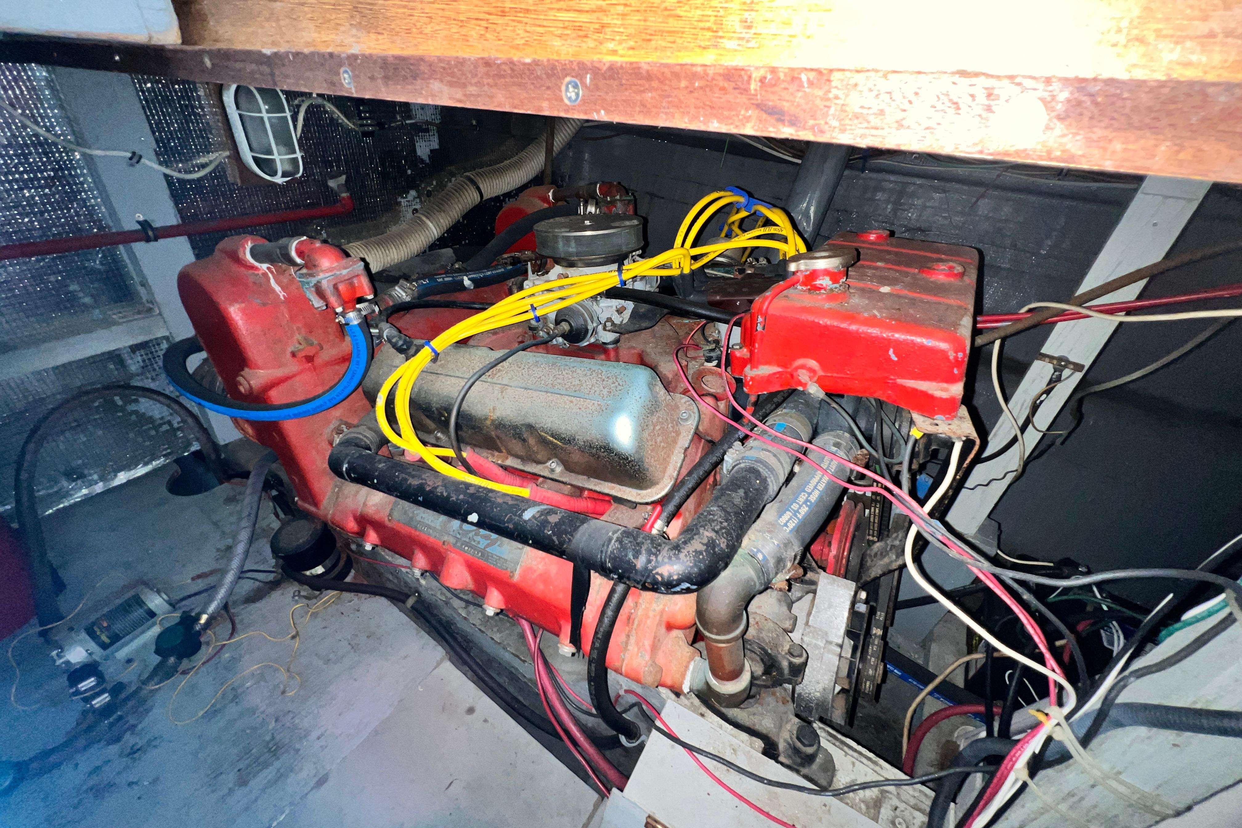 Engine compartment of a 1967 Chris-Craft 38 Constellation boat with visible wiring and components.