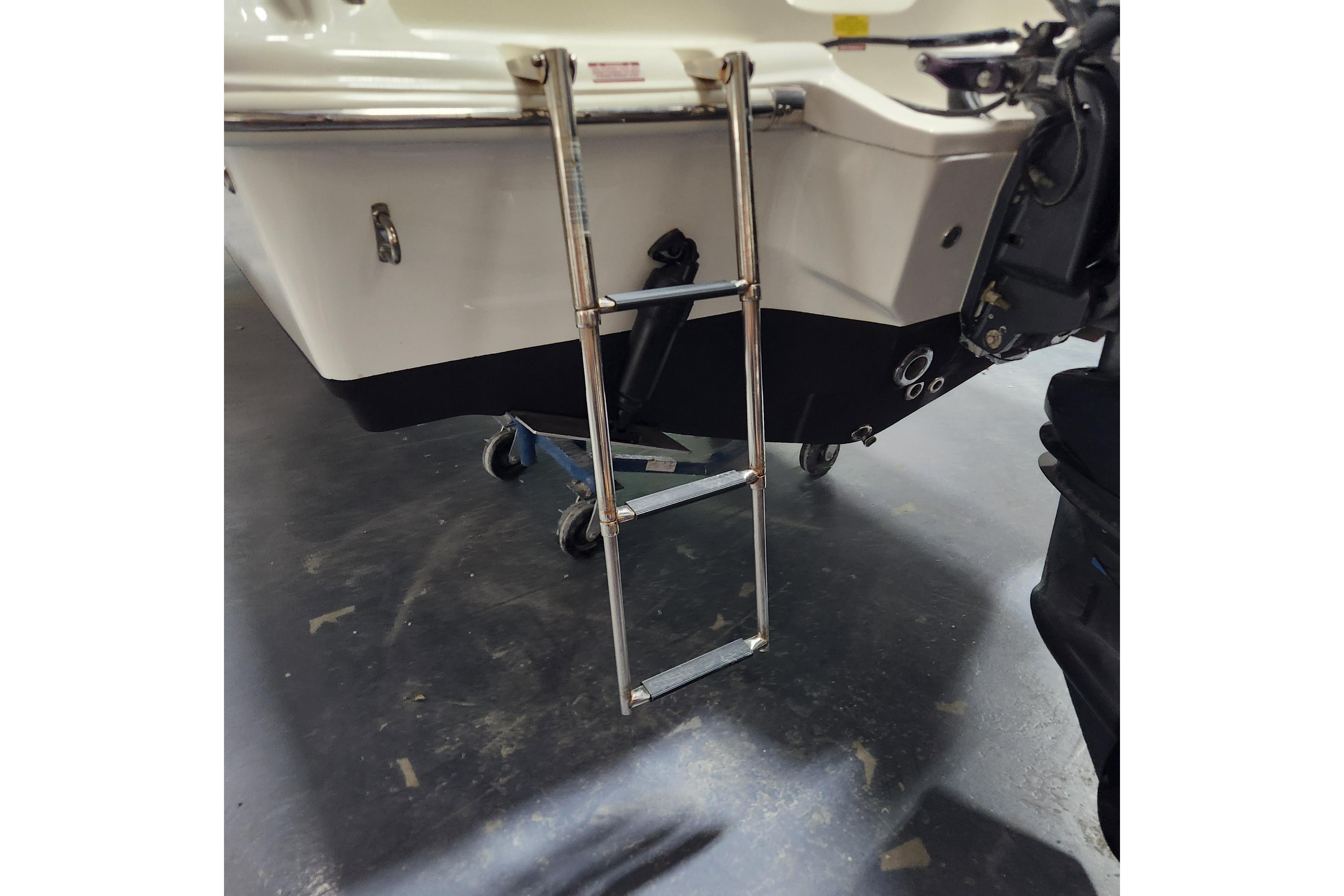 2023 Key West 219 FS boat with a metal boarding ladder.
