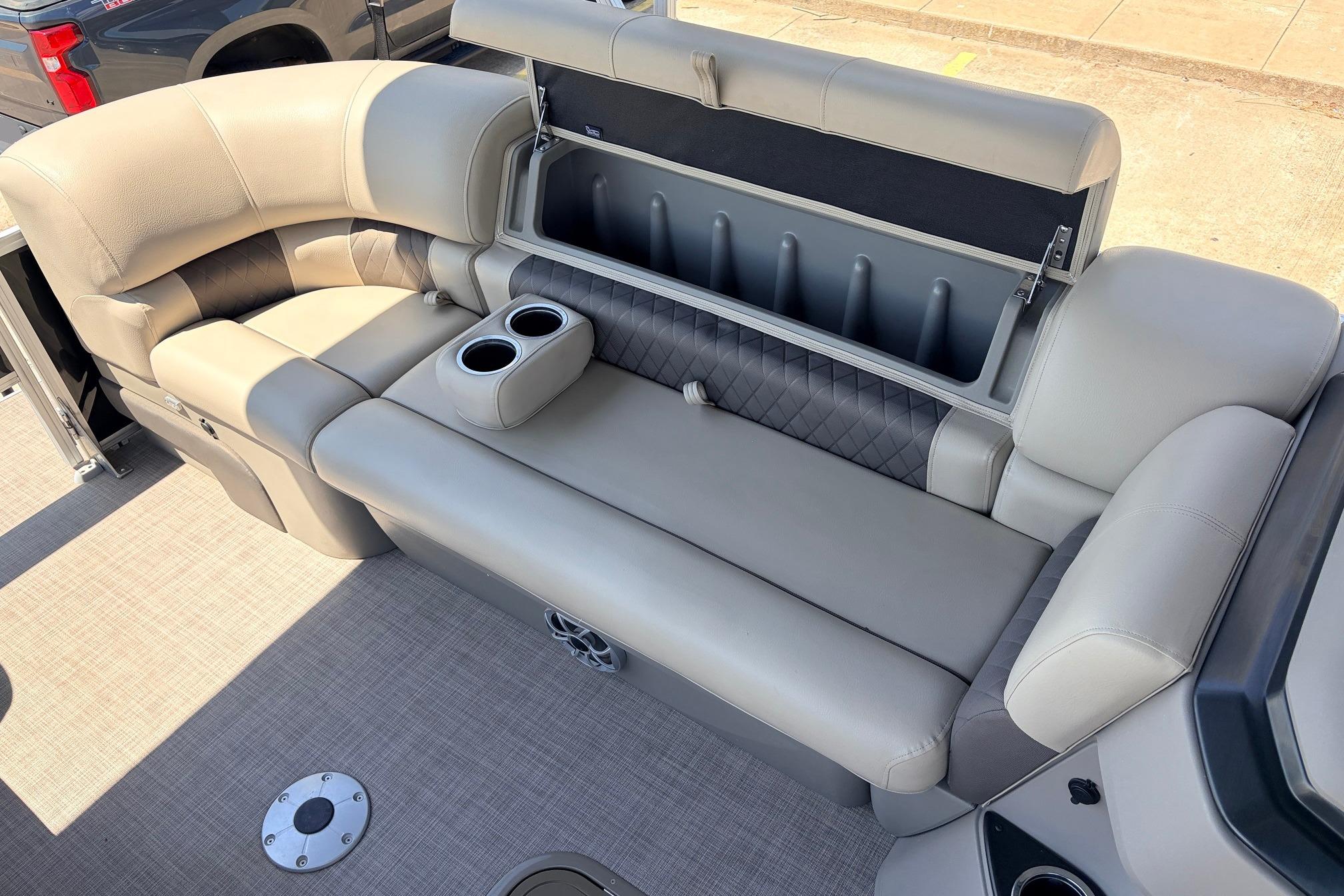 2024 Sun Tracker SportFish 22 XP3 boat interior with cushioned seating and storage.