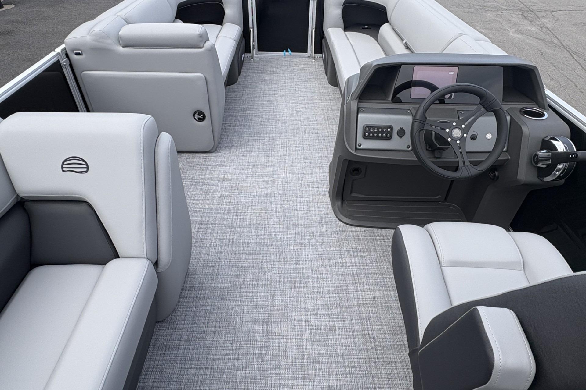 2026 Sun Tracker Party Barge 20 DLX interior with modern seating and steering console.