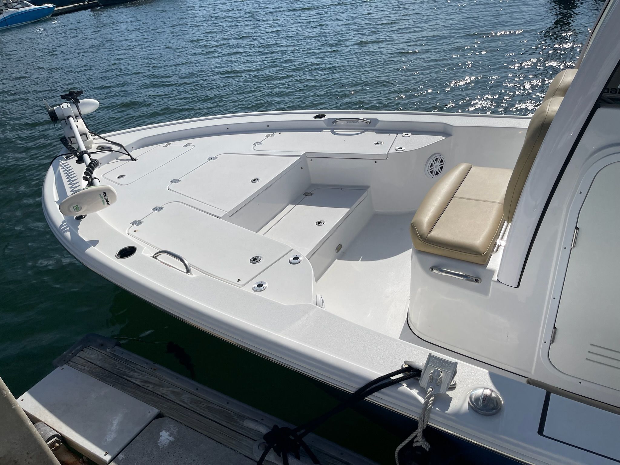 The 2022 Sportsman Masters 247 Bay Boat is docked. It features a clean, white deck.