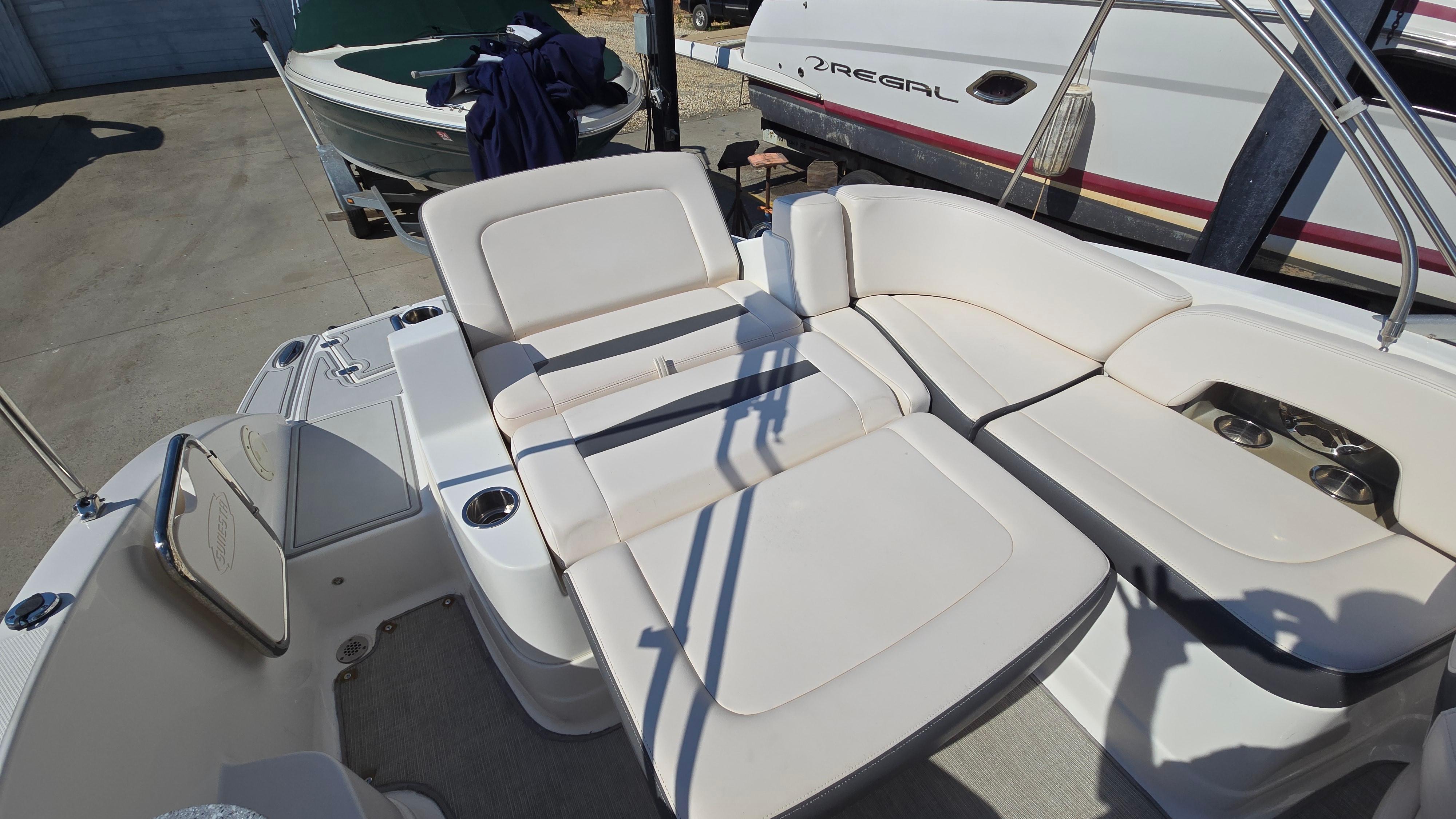 2018 Chaparral 224 Sunesta boat interior with white seating and cup holders.