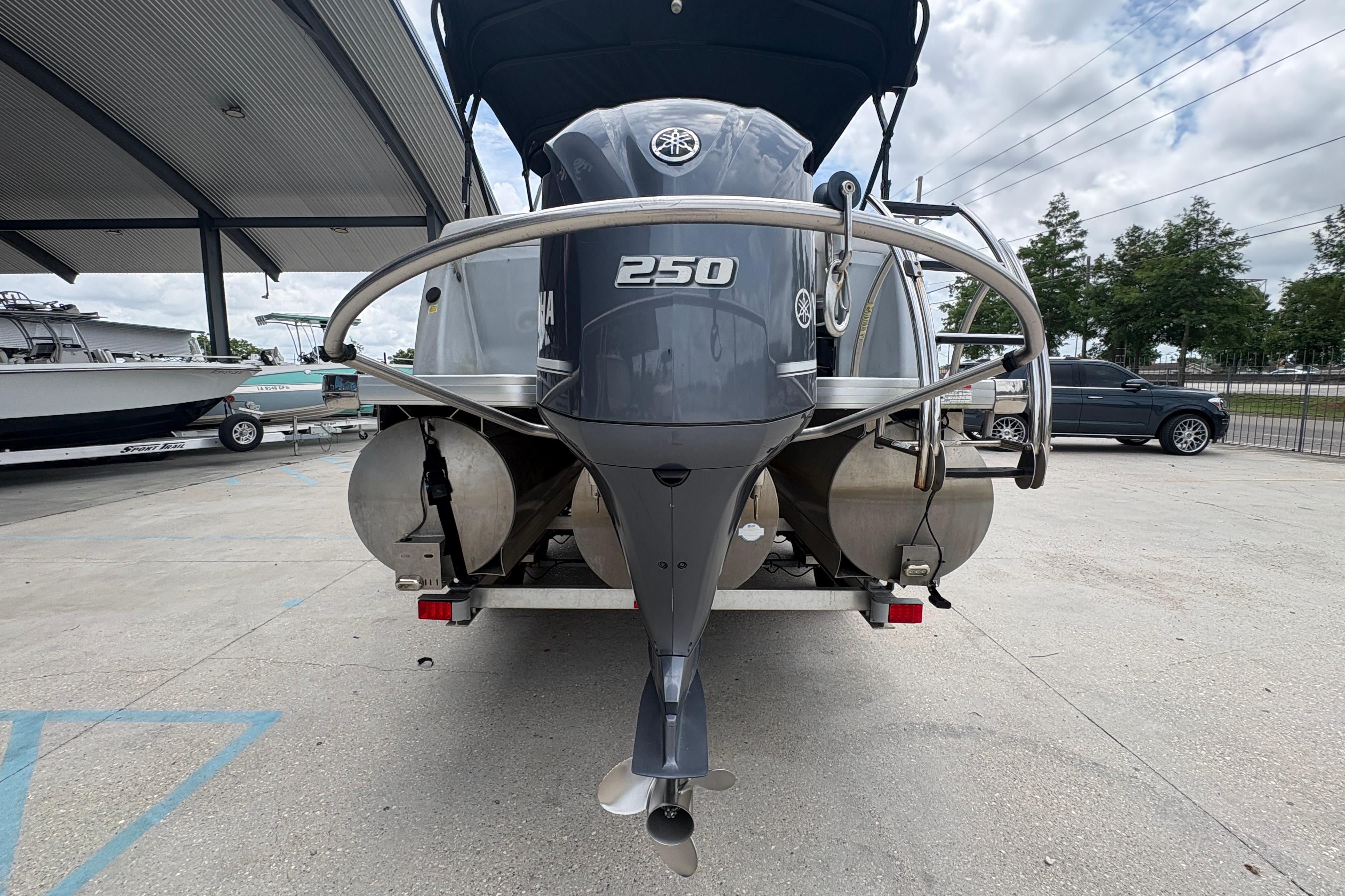 2019 Godfrey Aqua Patio boat with Yamaha 250 engine, parked outdoors.