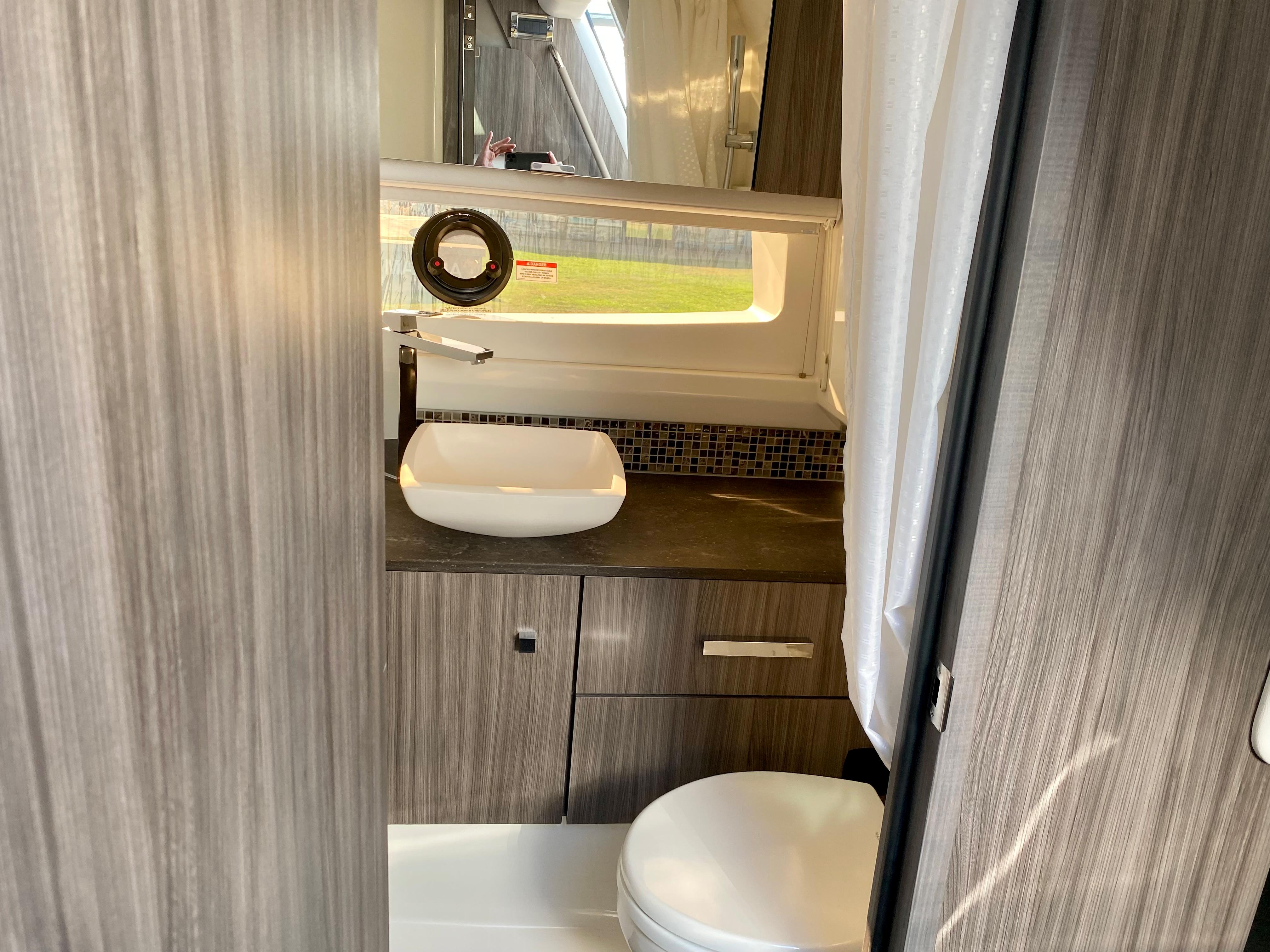 Interior of 2021 Sea Ray SLX 400 Outboard featuring modern bathroom.
