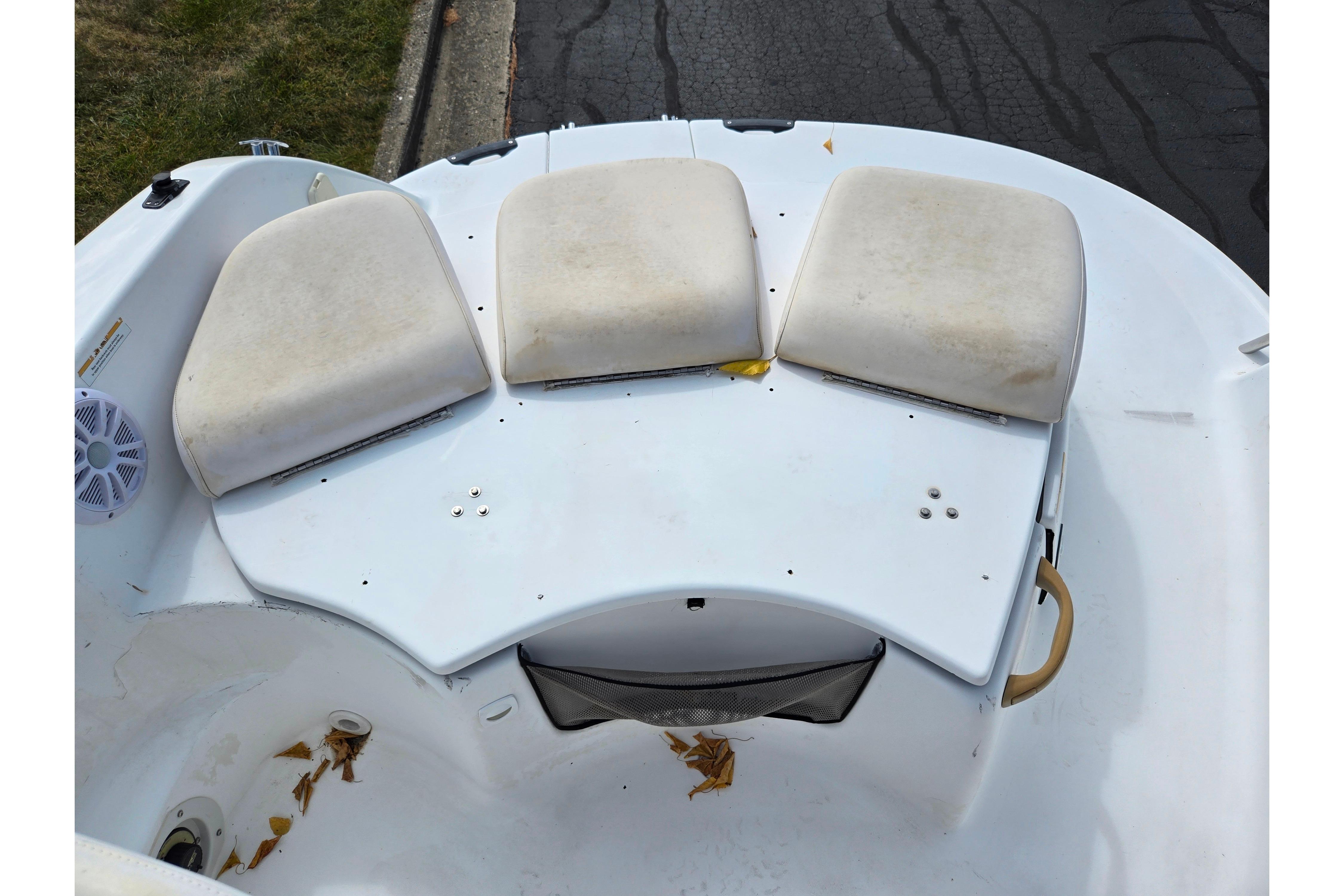 2004 Sea-Doo Islandia boat seating area with white cushions and storage compartment.