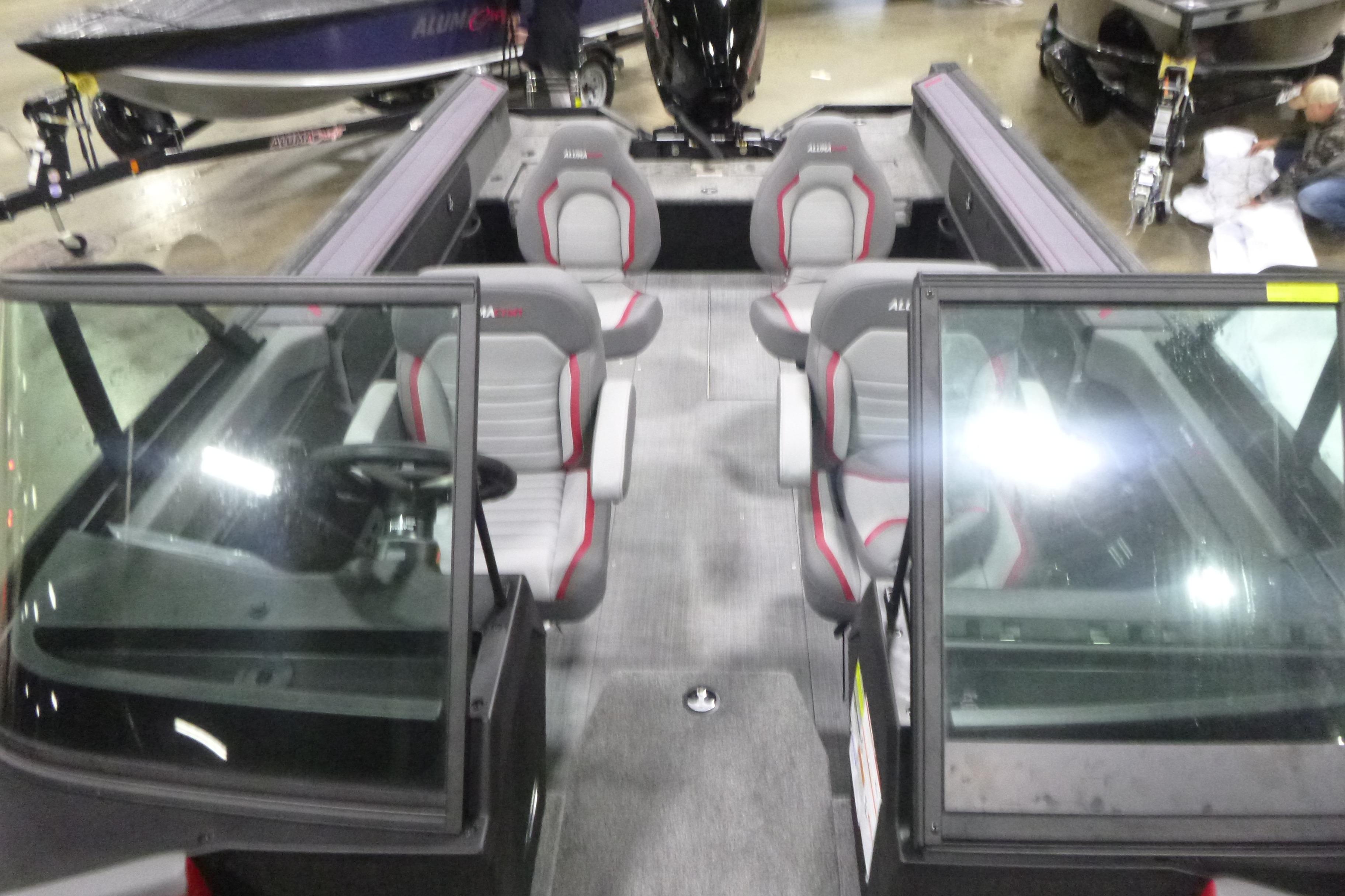 2026 Alumacraft Trophy 205X Sport boat interior with seating and steering console.