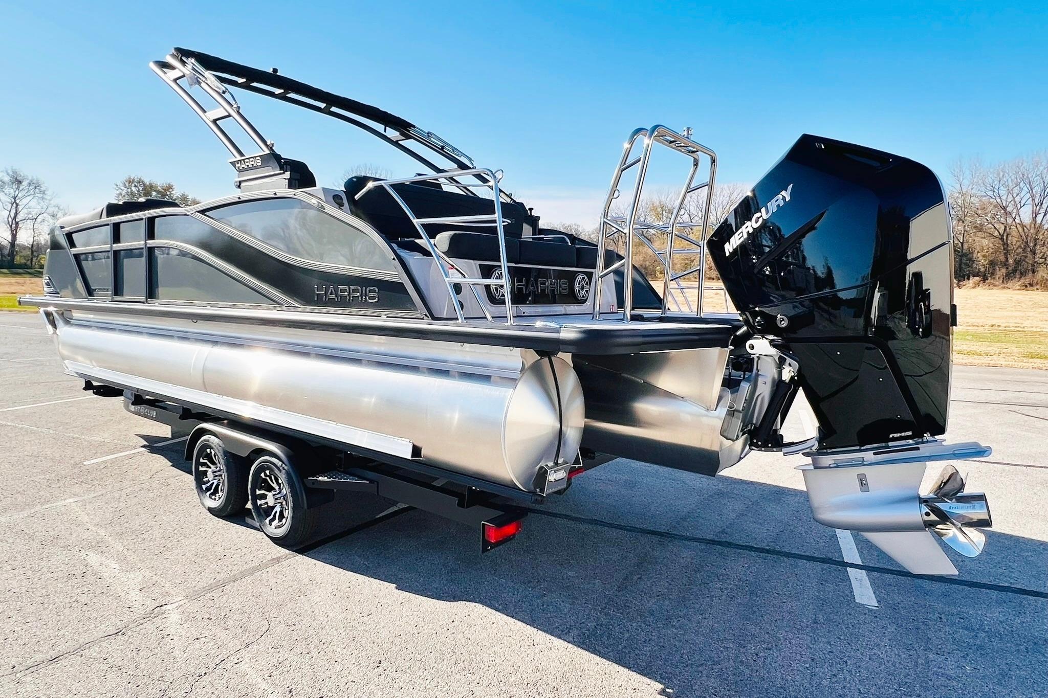 2026 Harris Grand Mariner 230 pontoon boat with Mercury outboard engine on trailer.