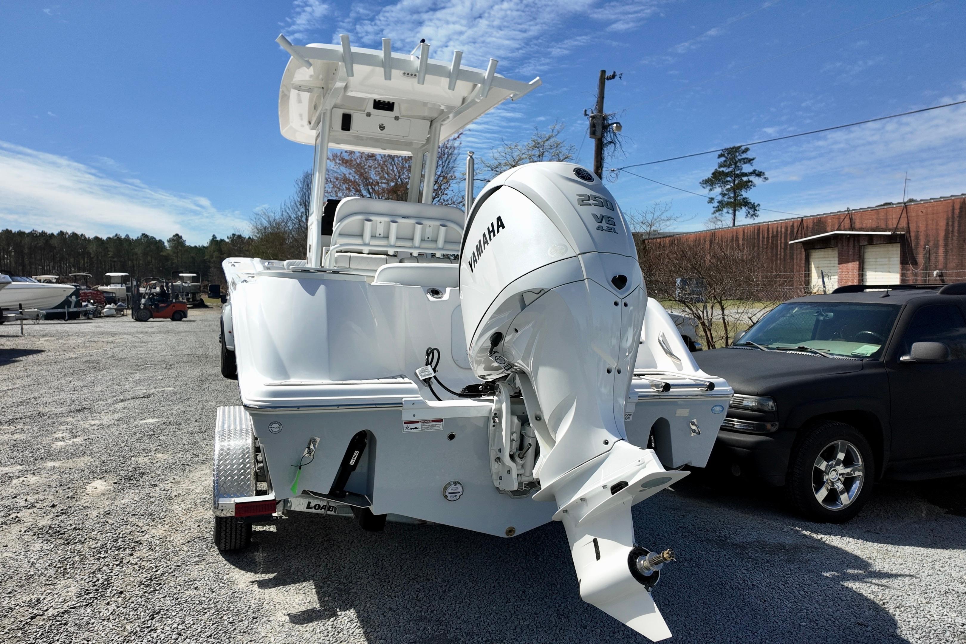 2026 Sea Fox 248 Commander boat with Yamaha engine, parked outdoors on gravel.