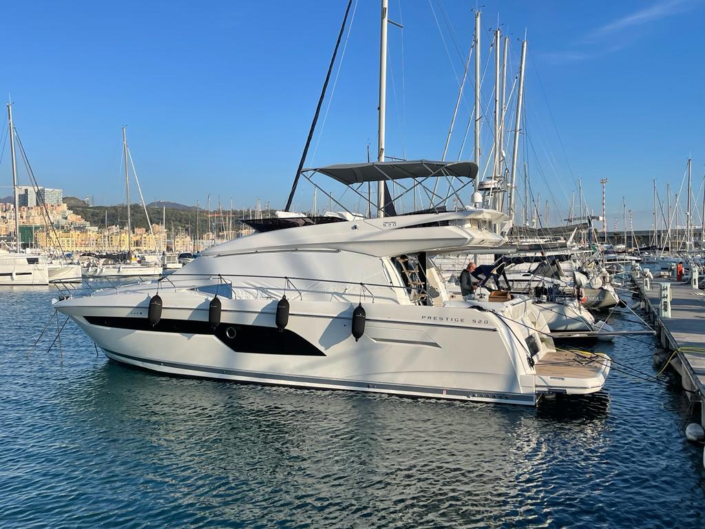 2022 Prestige 520 yacht docked in marina.