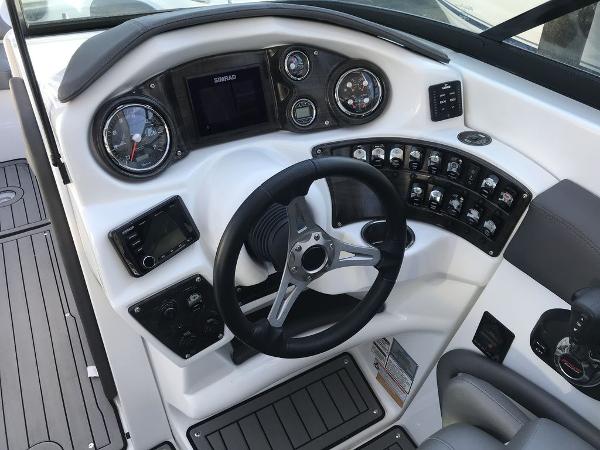 2020 Rinker 29QX BR boat dashboard with steering wheel and control panel.