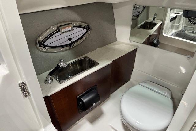 2026 Chaparral SSX 8 boat interior with sink, toilet, and mirror.