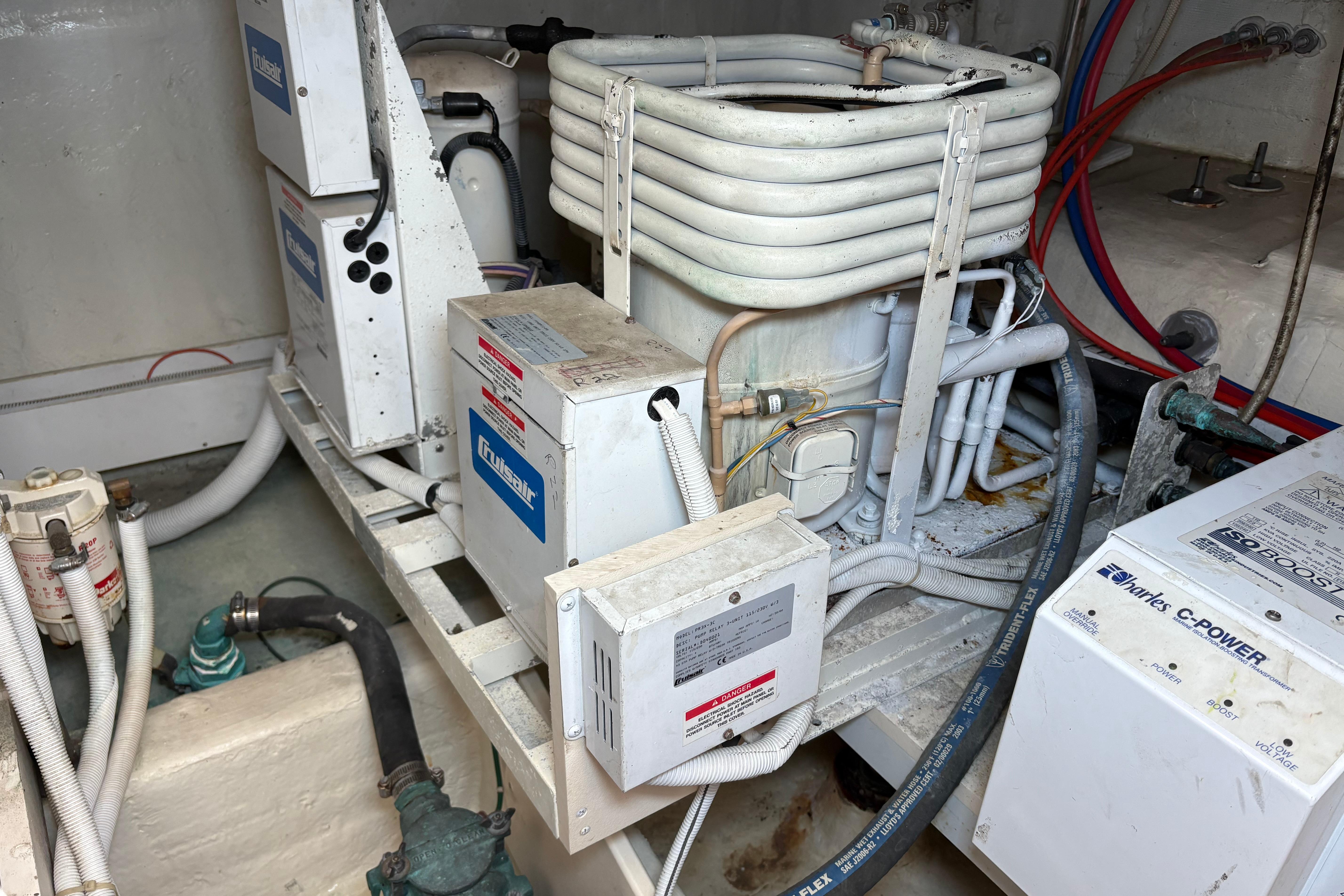 Engine room of a 2004 Carver 560 Voyager yacht, featuring mechanical components and wiring.
