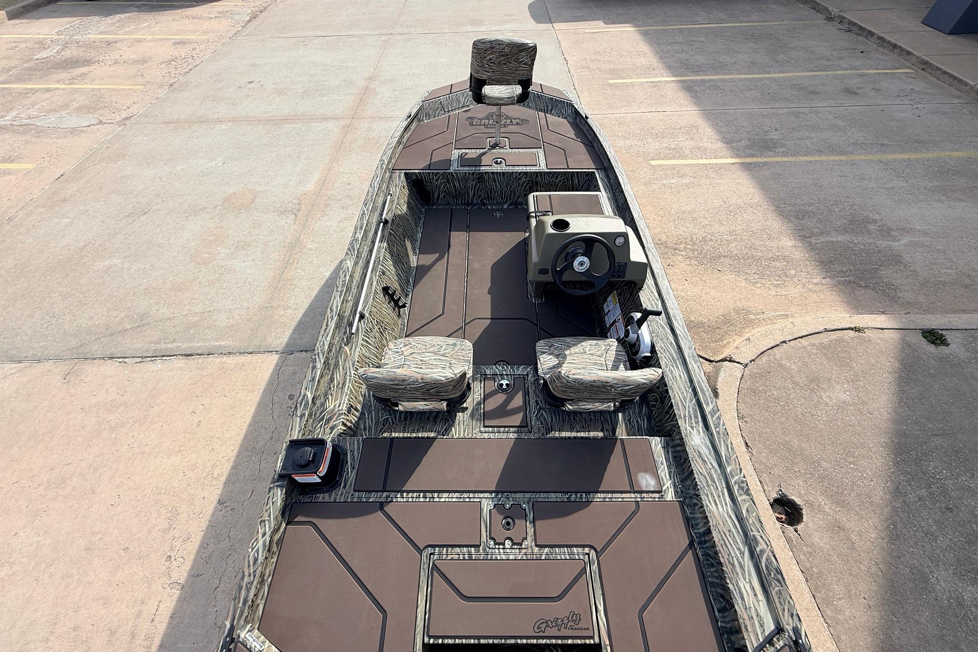 2026 Tracker Grizzly 1754 SC boat with camo seats and steering console.