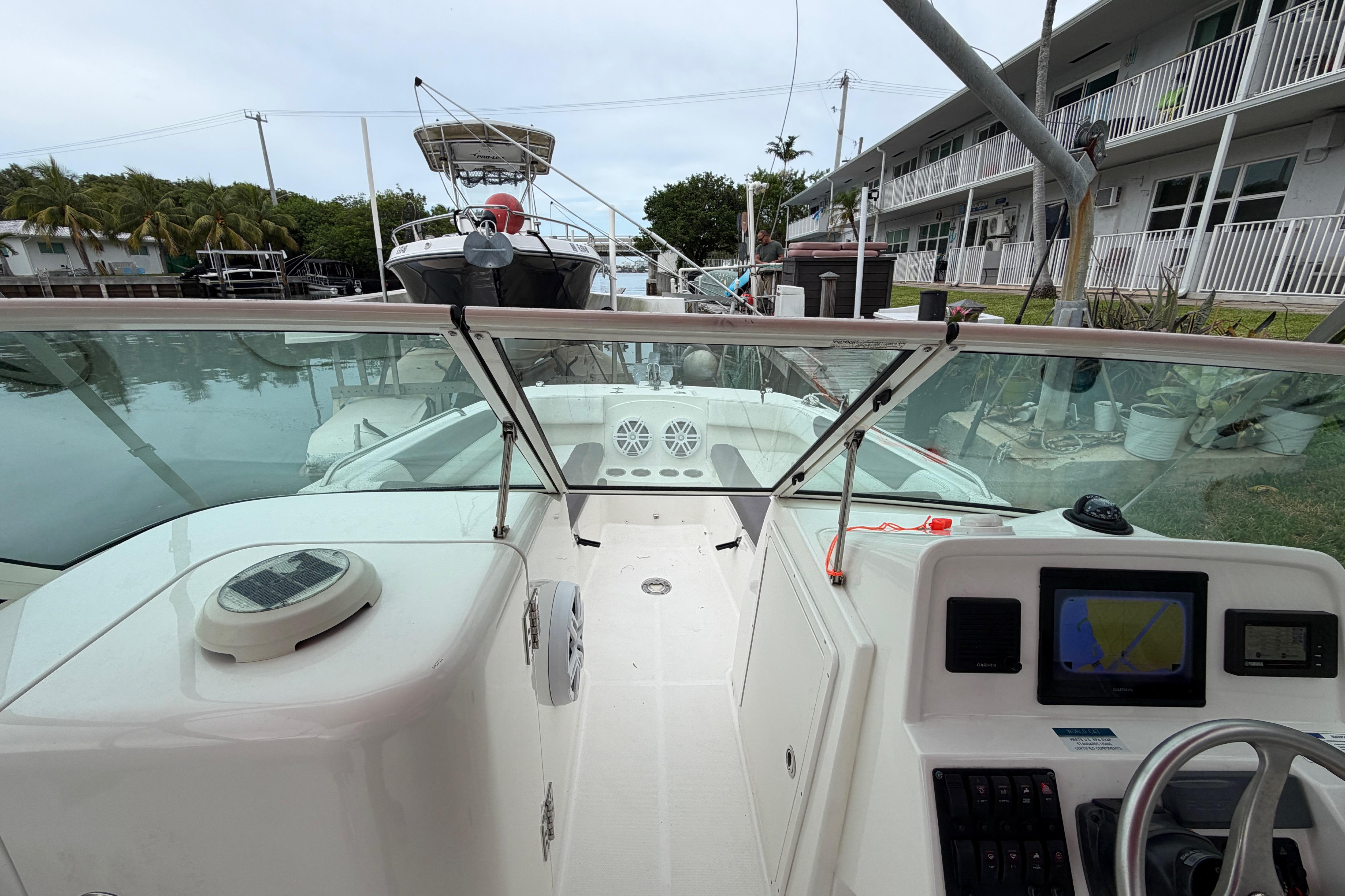 2019 World Cat 230 DC boat interior with navigation system and waterfront view.