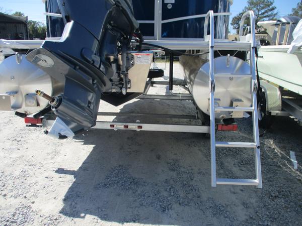 Starcraft LX16R 2025 boat rear view with motor and ladder on gravel.