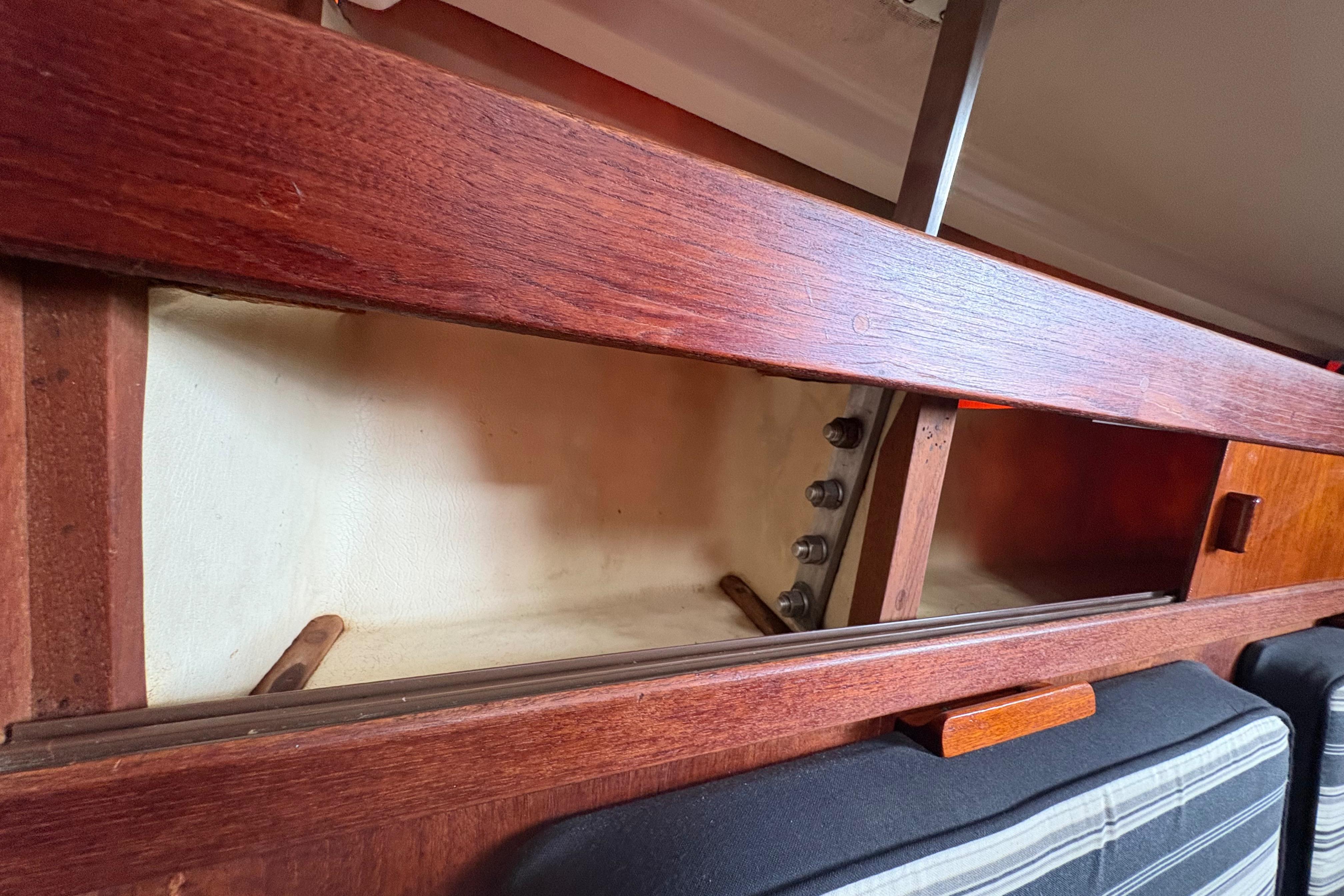 Interior storage compartment of a 1981 Sabre 31 sailboat with wooden finish.