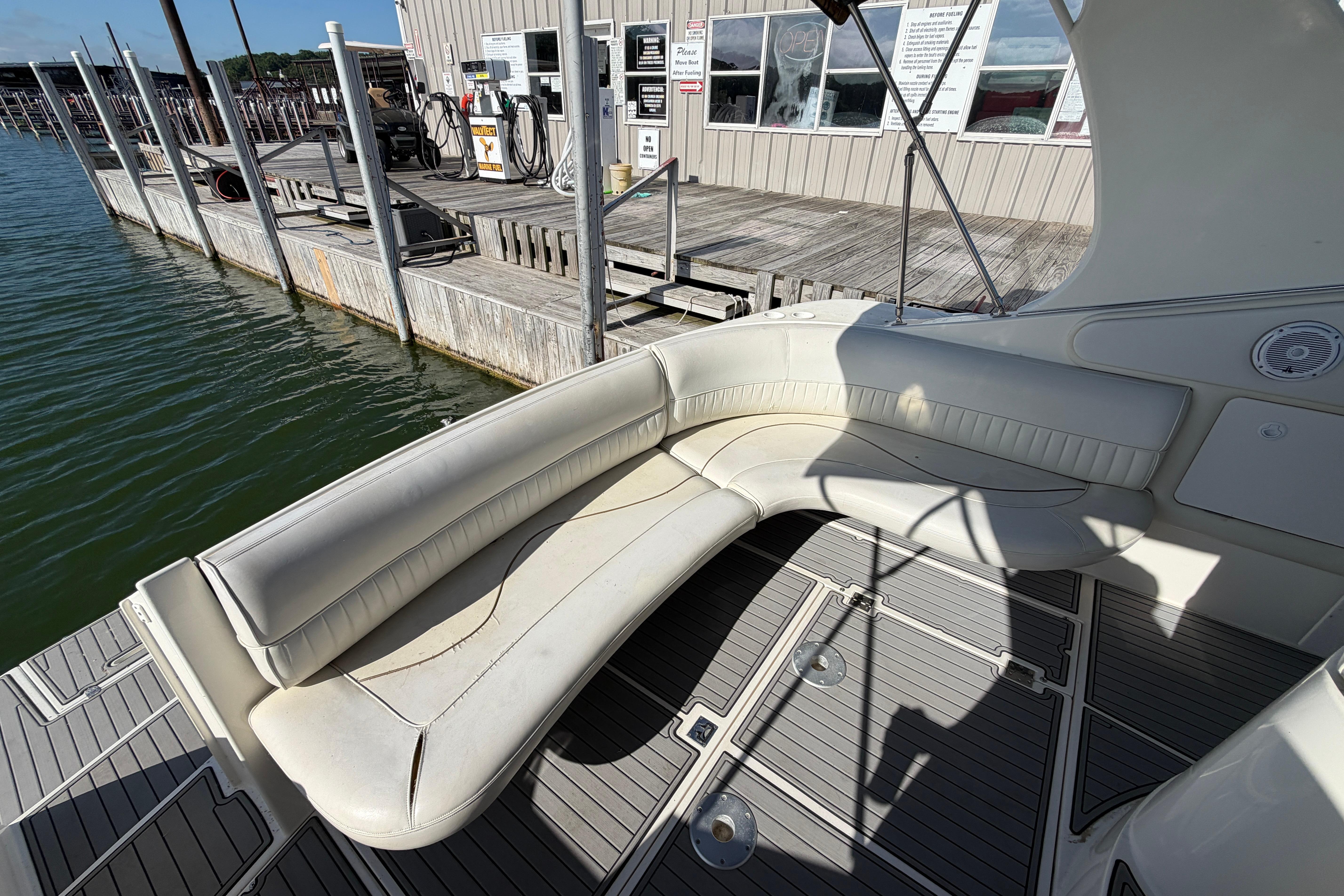 1997 Cruisers 3575 boat with white seating at a dockside marina.