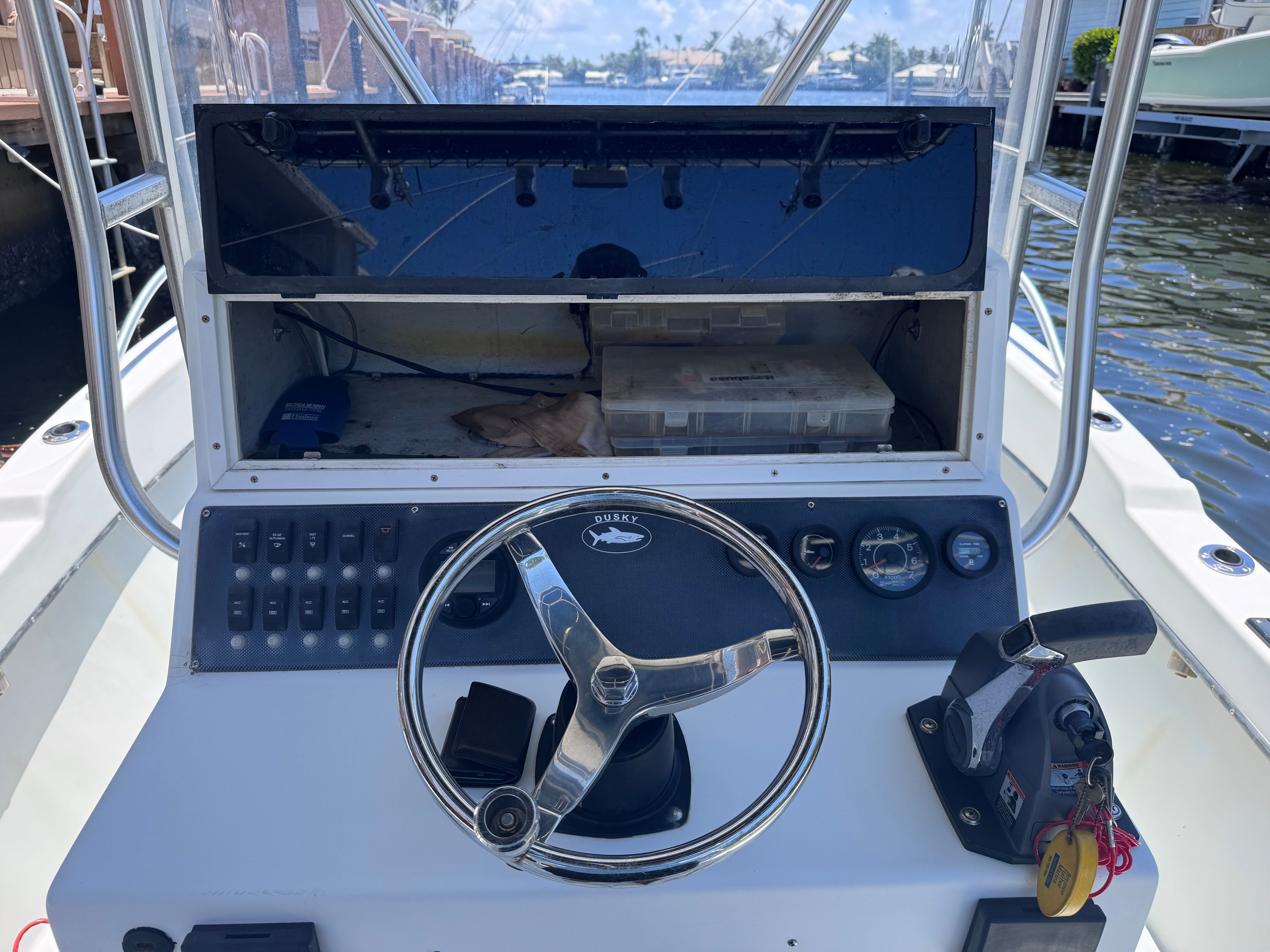Dashboard of a 1998 Dusky 20.3 boat with steering wheel and instruments.