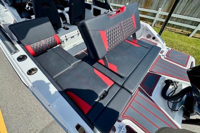 2026 Monterey Elite 25 OB boat interior with black and red seating, showcasing modern design.