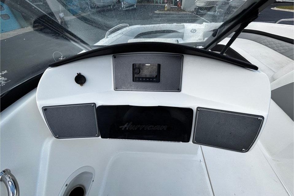 Dashboard of 2022 Hurricane SunDeck 217 OB boat with control panel and speakers.