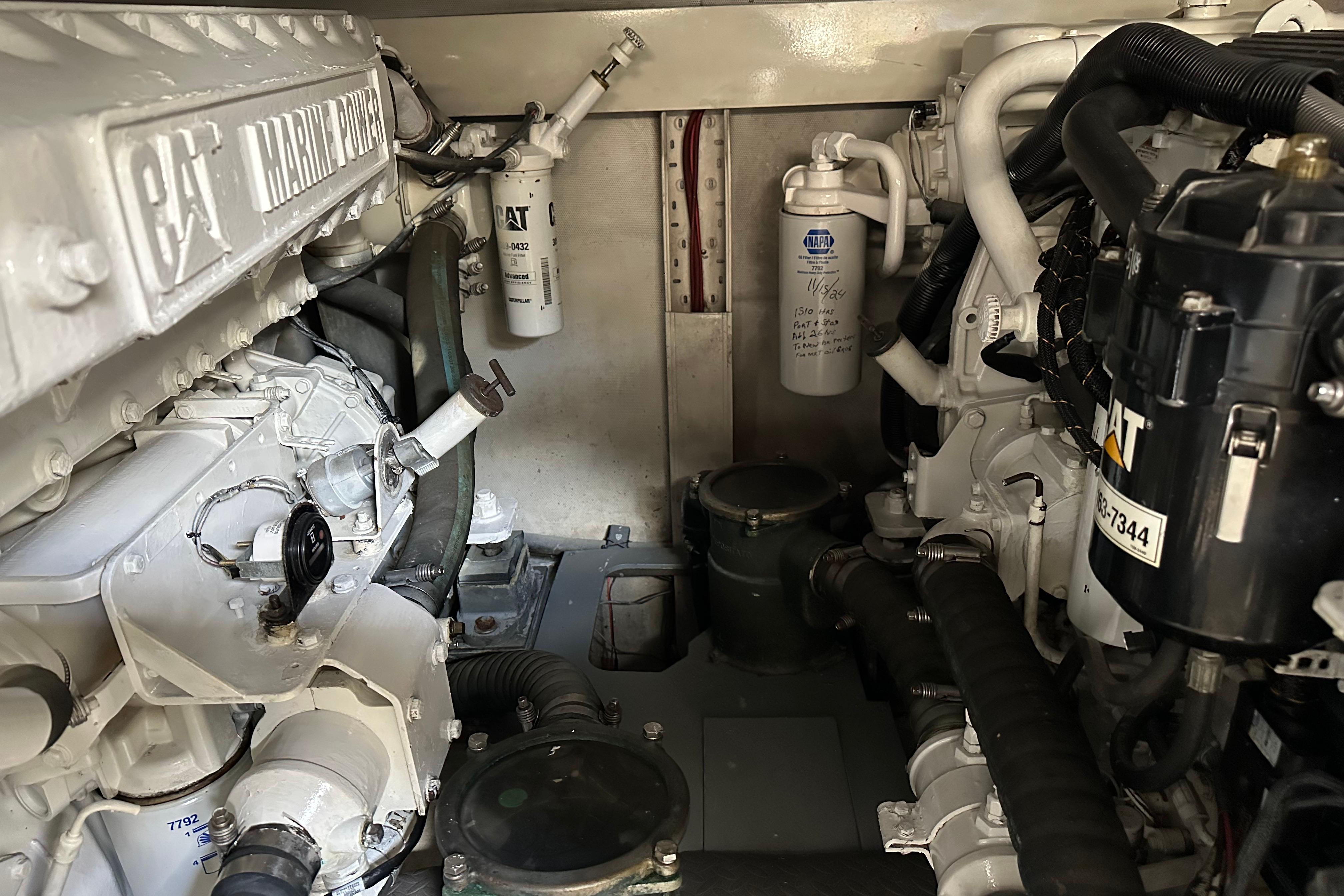 Engine room of a 2004 Azimut 55E yacht featuring CAT marine power components.